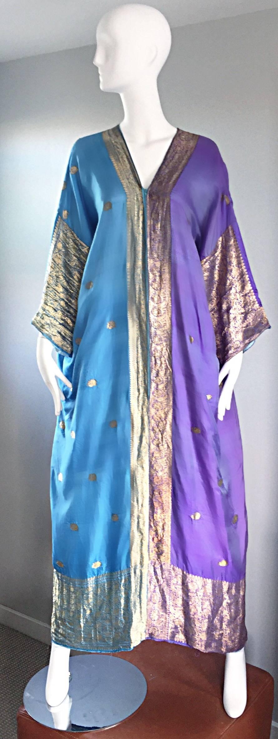Incredible 1970s raw silk Indian inspired caftan maxi dress! Features the softest silk ever, with gold silk embroidery throughout. Light purple panels compliment the light blue panels. Hidden zipper up the front controls the amount of cleavage