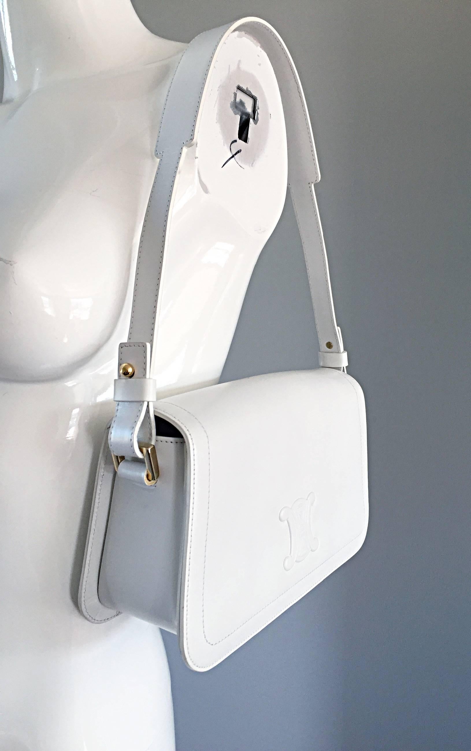 Chic brand new (never used) vintage CELINE stark white leather structured handbag! Features soft structured leather, with the embossed Celine logo on the front flap. Strap can be removed to use as a clutch. Shoulder strap features a wider top in