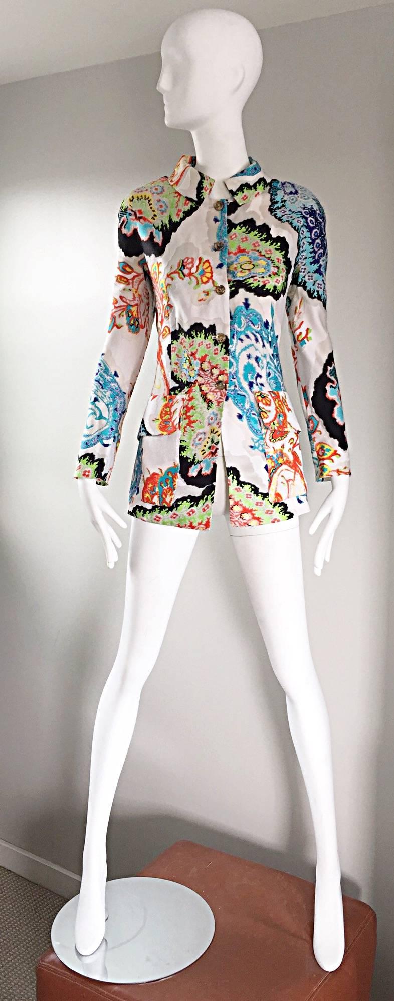 Incredible vintage CHRISTIAN LACROIX embroidered blazer jacket! Features vibrant colorful hand embroidery work throughout. Ivory background, with blue, orange, green, yellow, and black embroidery. Two pockets at both sides of the waist. Horn colored