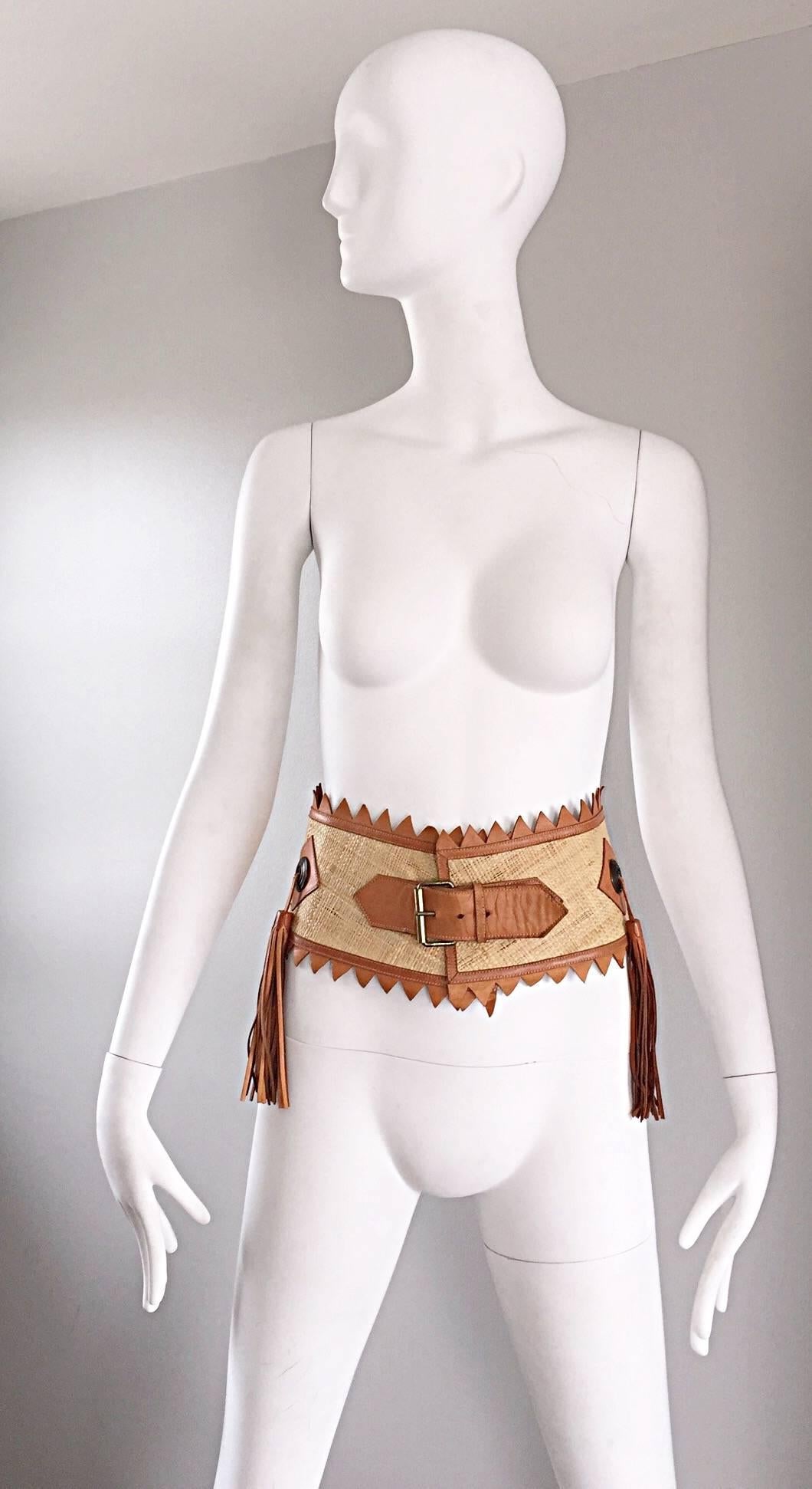 Amazingly chic vintage 1970s leather and straw boho wide belt! Features tan straw, intermixed with leather. Two tassels at each side, and one tassel in the back. Adds just the right amount of style to any outfit! Great with jeans, shorts, a skirt,