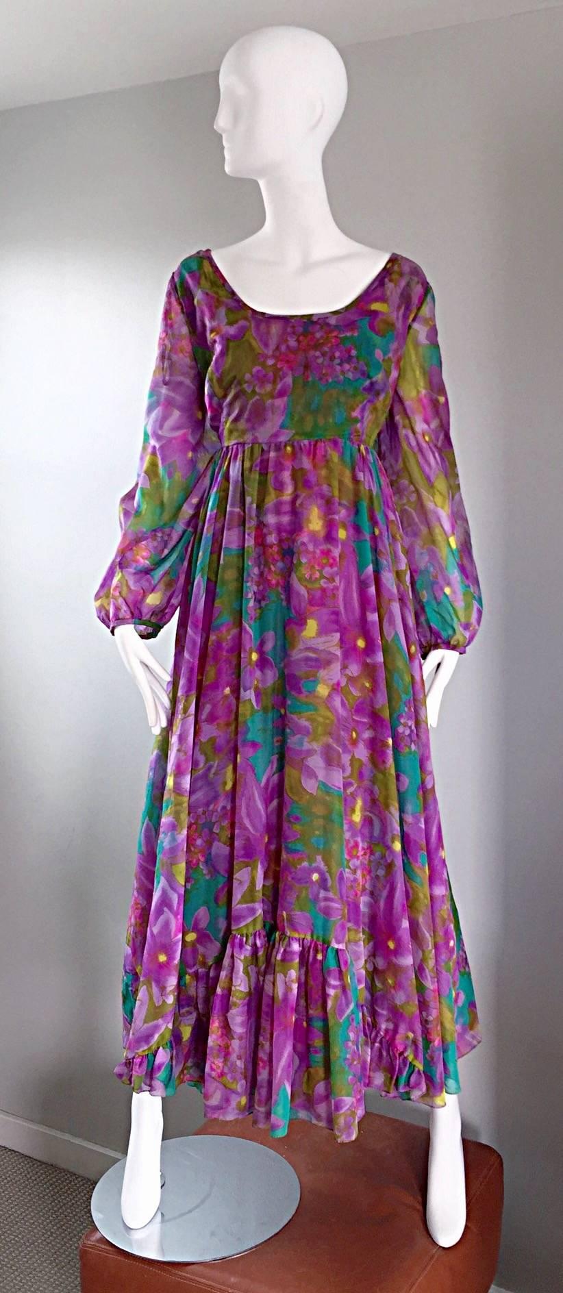 Sensational vintage 1970s MR BLACKWELL plus size maxi dress / gown! Vibrant hues of purples, blues, yellows and greens in a floral tropical print. Peasant style, with semi sheer billowy sleeves, and a full skirt. Ruffles at both the center front and