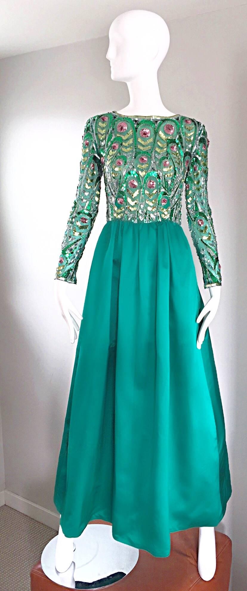 Sensational vintage 60s VICTORIA ROYAL Couture Kelly green full length evening gown! Fitted bodice features thousands of hand-sewn sequins and beads throughout. Metal zipper at each interior sleeve makes for a tailored fit. Full Kelly green satin