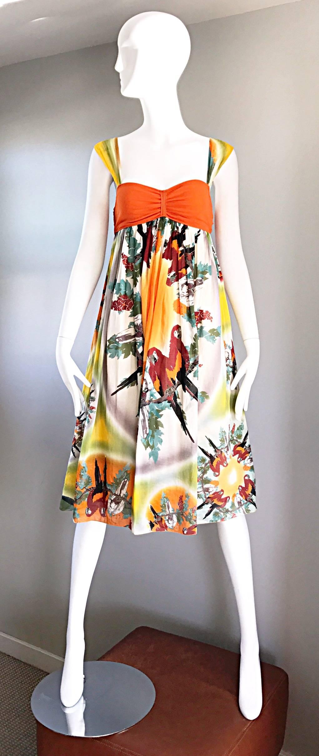 Amazing vintage 90s JEAN PAUL GAULTIER sun dress! Tropical meets boho! Features a bright orange bodice in Gaultier's signature mesh, with printed cotton cap sleeves. Empire waist, with a full cotton skirt. Vibrant print of parrots throughout the