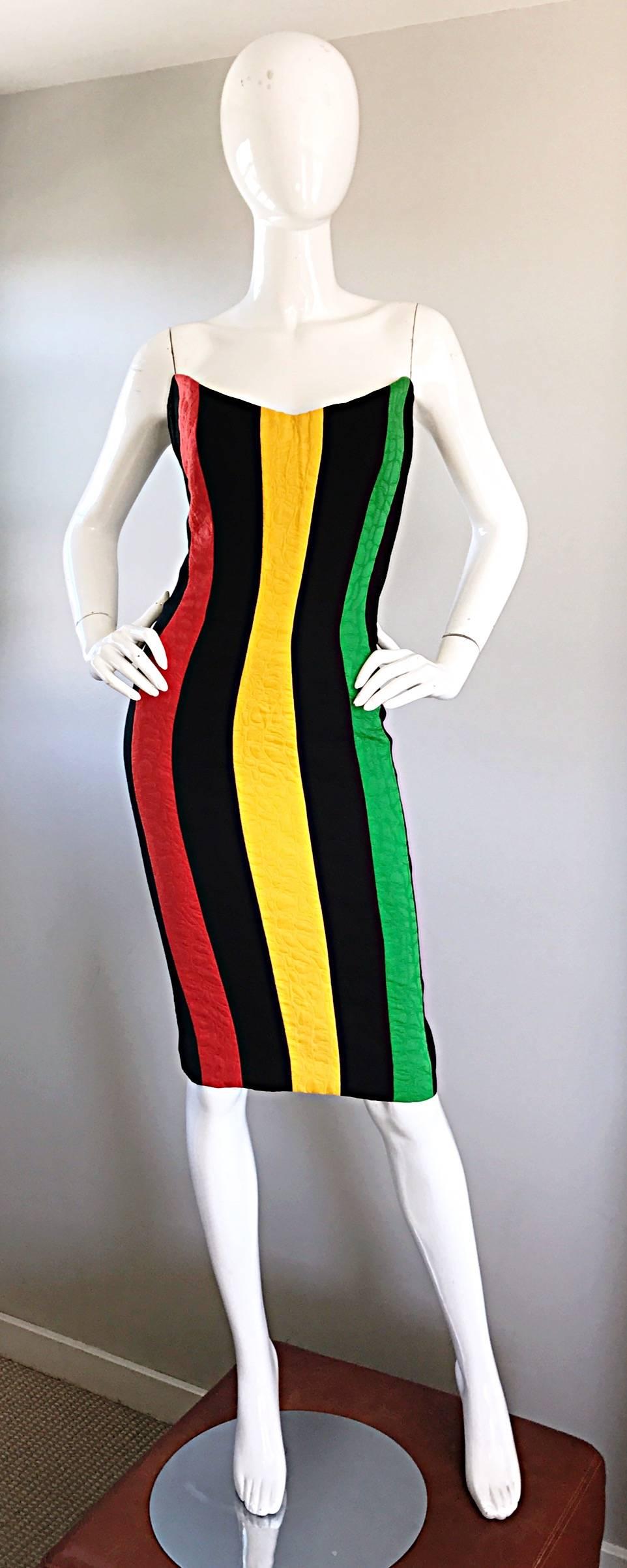 Rare and incredible vintage BOB MACKIE strapless dress! Features slimming red, yellow, black and green vertical stripes up the front, with a solid black back. Heavy duty textured cotton. Fully lined. Boned bodice with interior support help keeps