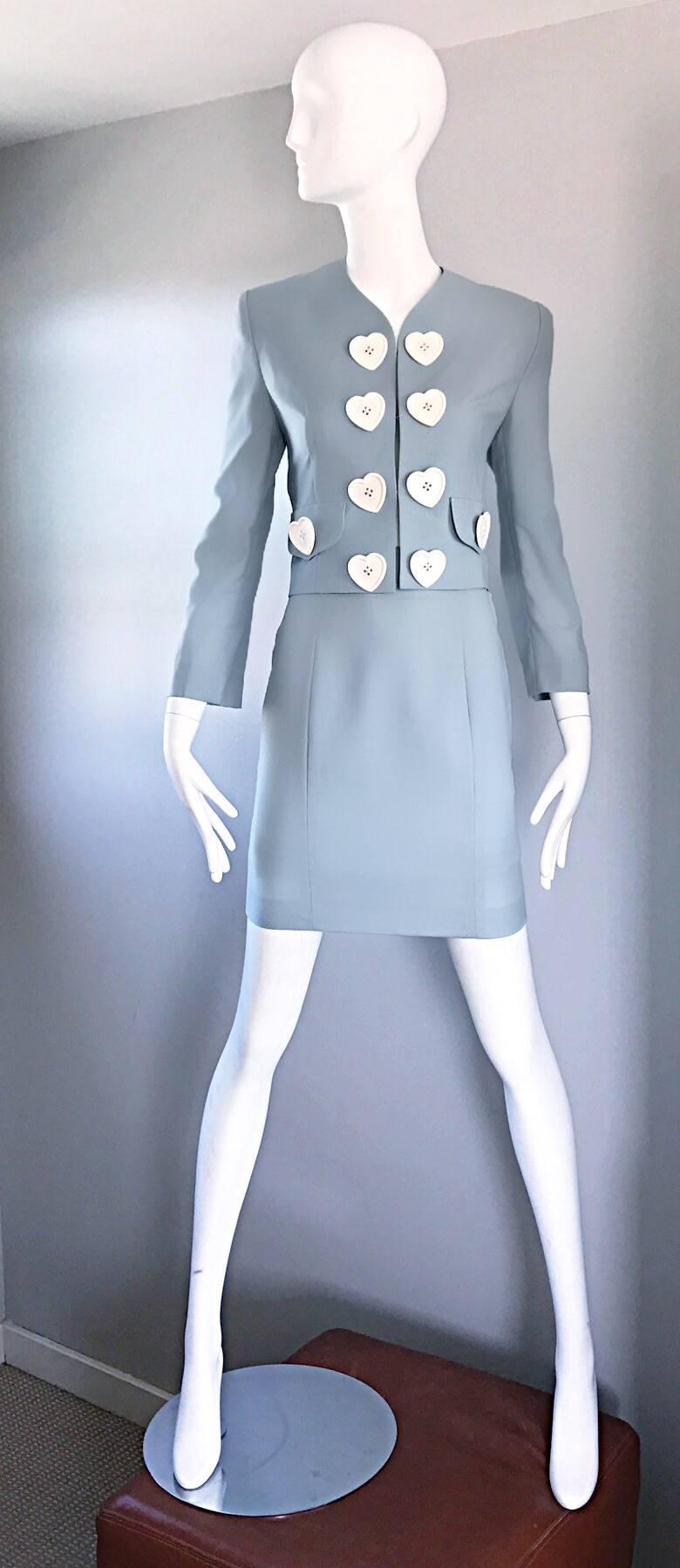 Amazing vintage 90s MOSCHINO Cheap & Chic light blue skirt suit! Wonderful tailored fit, with a high waisted pencil skirt and 1960s style jacket! Oversized white heart plastic buttons adorn the front of the blazer. Hook-and-eye closures up the