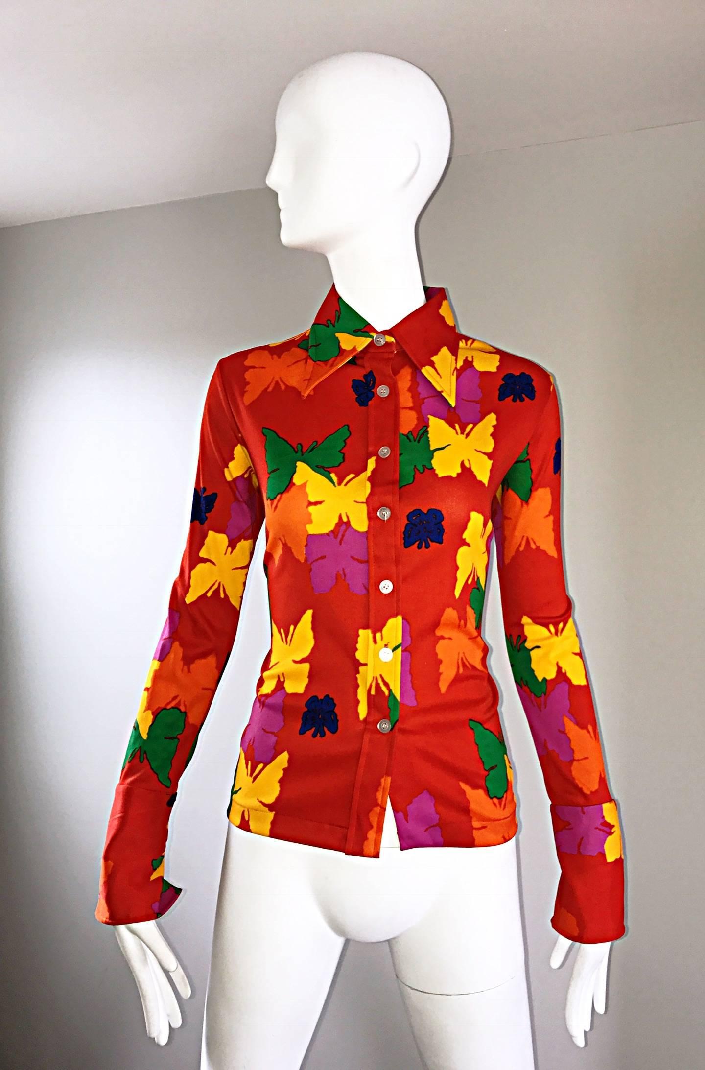 Amazing 1970s ANDREW ST JOHN bright neon orange colorful butterfly disco blouse! Features screen printed pink, yellow, green, blue and orange butterflies throughout. Chic exaggerated signature 70s lapels. Fitted bodice stretches to fit. Buttons up