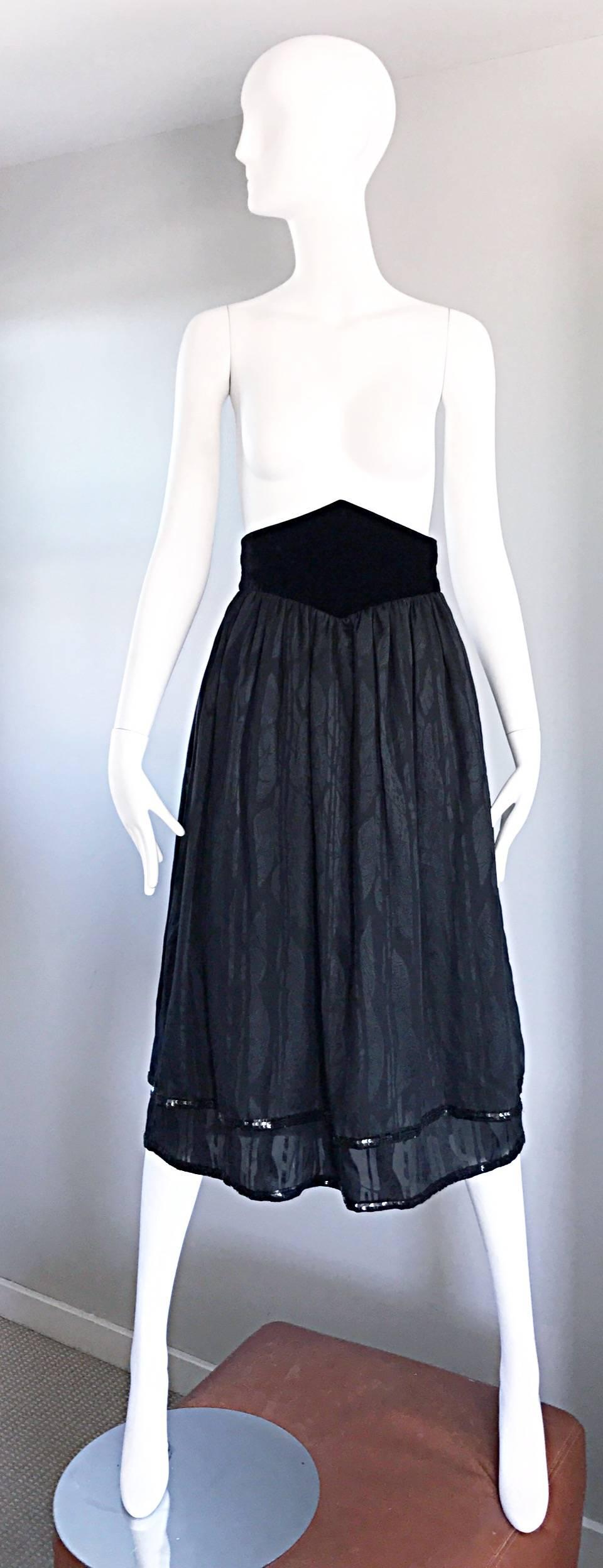 Beautiful vintage VALENTINO black silk chiffon skirt, with intricate leaf motifs, and a double layered black sequin trim. Avant Garde high waisted black silk velvet diamond waistband. Exceptional couture quality. Double layers of the finest black