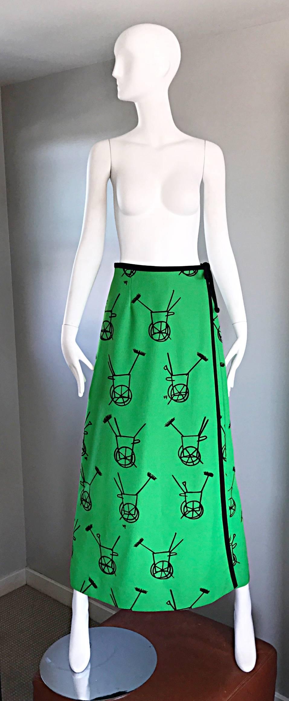 Amazing early 70s VESTED GENTRESS 'wheelbarrow' novelty print Kelly green and black wrap maxi skirt! Features wheel barrow carts throughout, with brooms sticking out. Vibrant green color, with a flattering flared fit. Hidden interior hook-and-eye