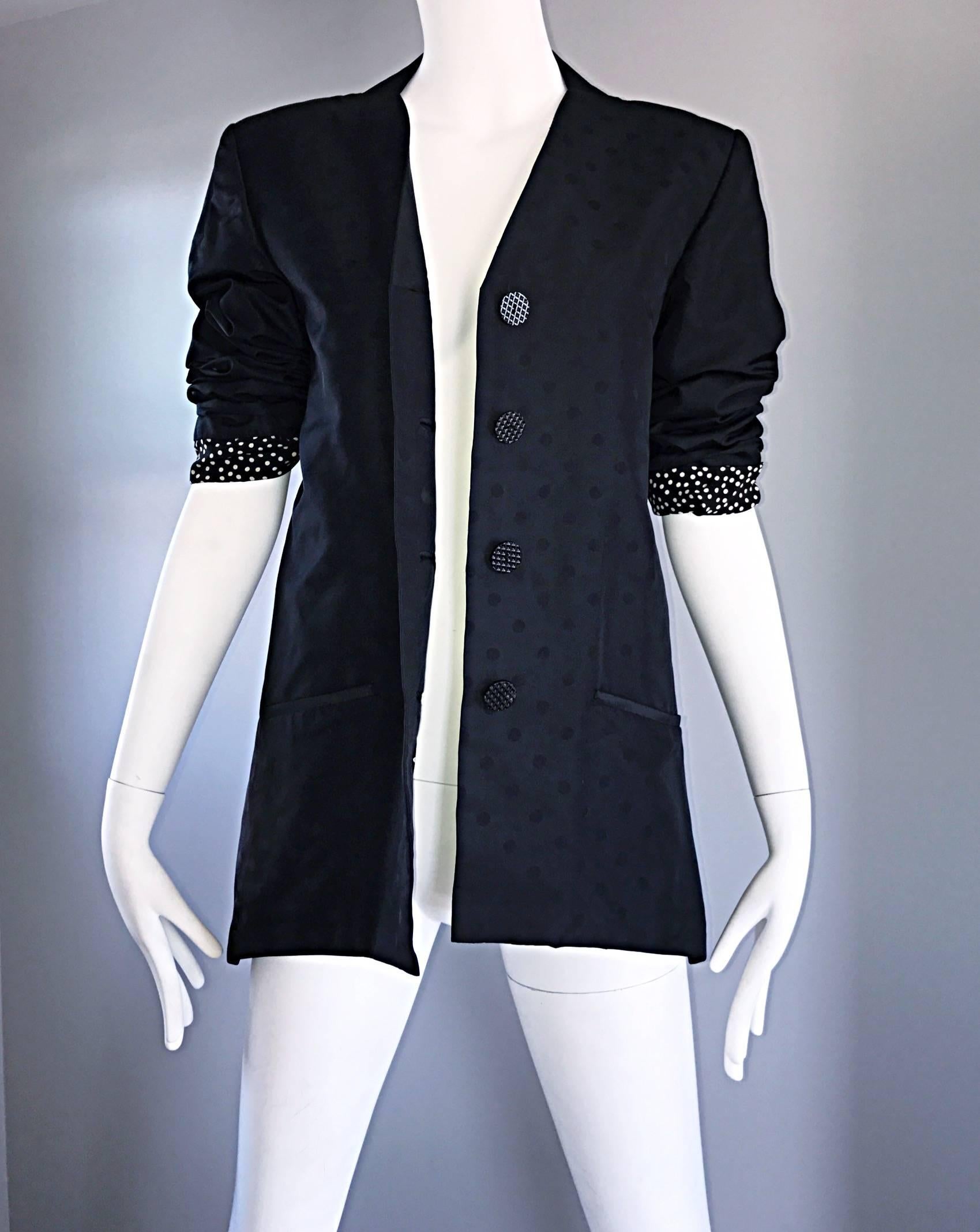 Chic vintage GEOFFREY BEENE classic black jacket! Features a discreet iridescent polka dot print throughout. Four buttons up the front. Pocket at each side of the waist. Lined in chic black and white polka dot printed silk that looks great exposed