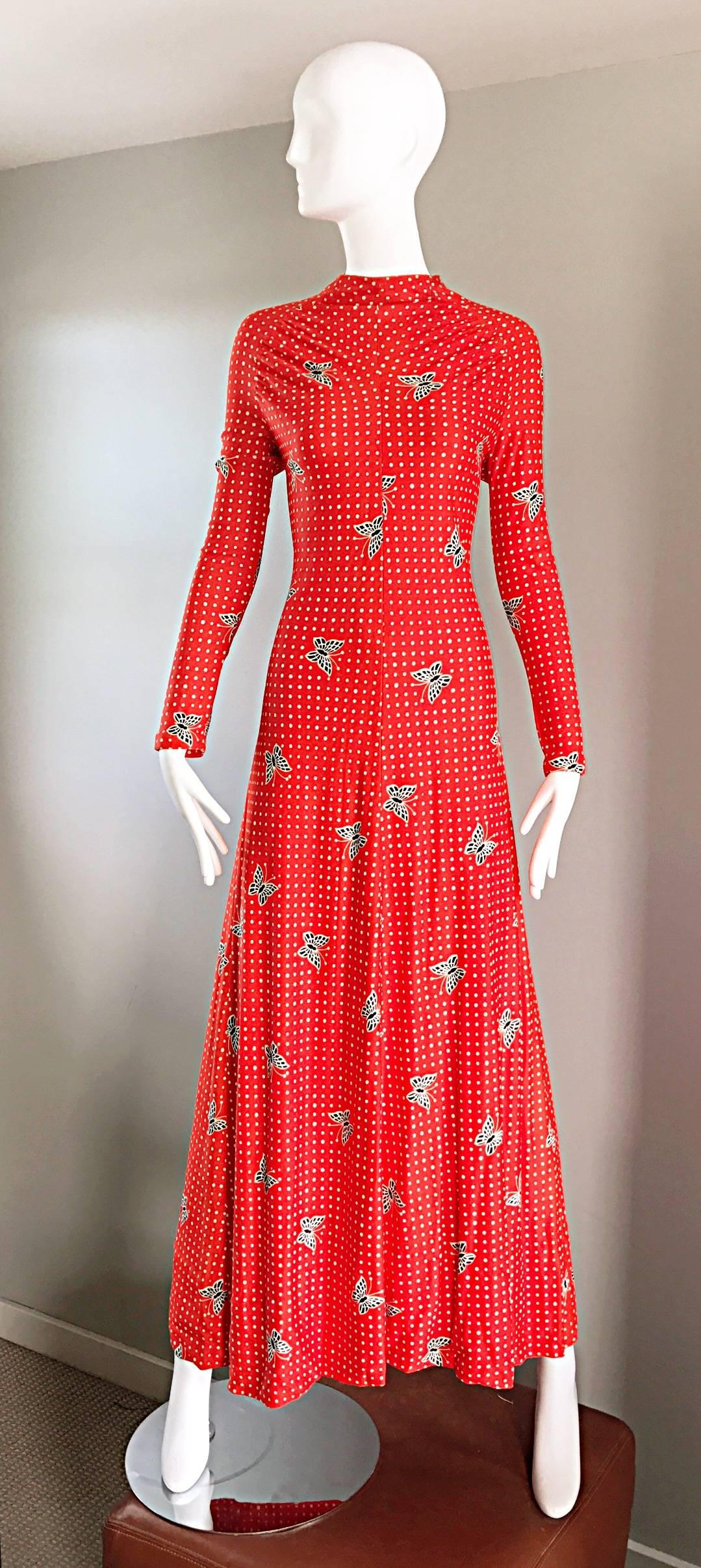 Amazing 70s bright orange / red butterflies and polka dots long sleeve jersey maxi dress! Navy and white butterfly print throughout, intermixed with white polka dots. Tailored bodice and long sleeve arms. Hidden zipper up the back. Looks great alone