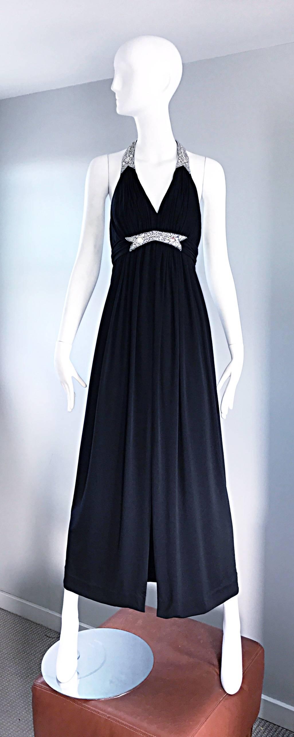 Stunning 1970s VICTORIA ROYAL black jersey evening dress! Grecian shilouette, with pleating at the bodice and waist. Hundreds of hand-sewn rhinestones of all different sizes at front waist, and along the neck line and strap. Three hidden