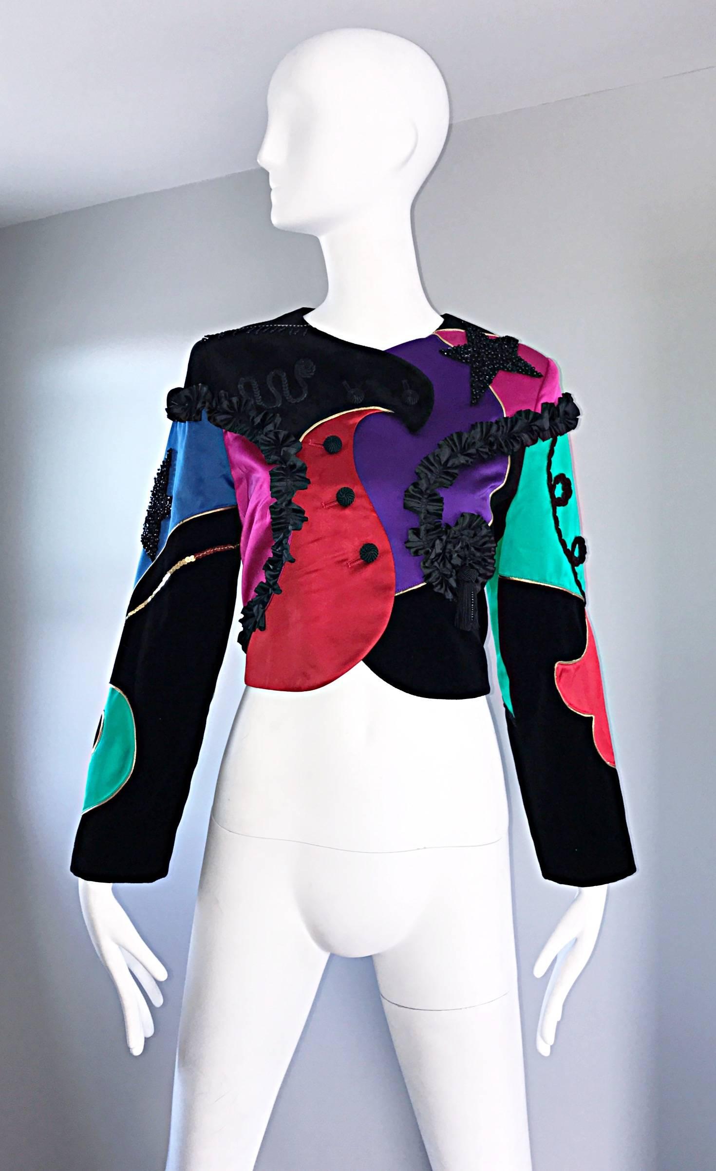 Rare and insanely chic vintage LOUIS FERAUD cropped matador style jacket! Super soft silk and velvet composition, with intricate embroiderery, sequins and beads throughout. Asymmetrically lined buttons up the front. Couture quality, with an amazing