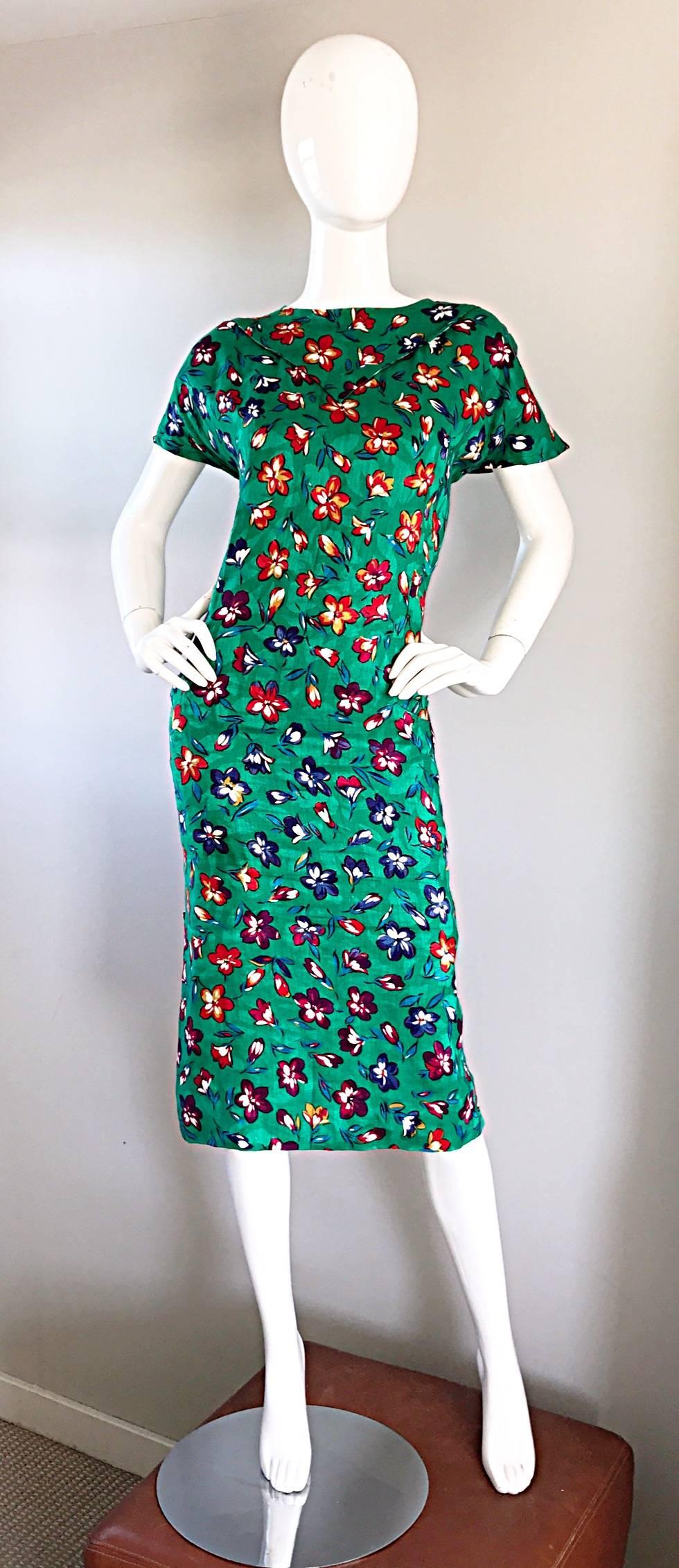 Gorgeous vintage EMANUEL UNGARO, for AMEN WARDY Kelly green 90s Size 14 dress! Vibrant green color, with purple, pink, yellow and blue floral prints throughout. Chic collar detail. POCKETS at both sides of the waist. Buttons up both sides of the