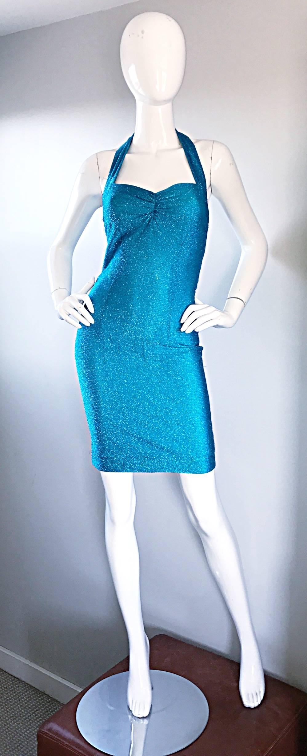 Sexy vintage 90s bright blue metallic Lurex Bodycon halter mini dress! Hugs the body in all the right places, with lots of attention to detail. Rushing at center bust. Bodice has a boned bodice to hold everything in place. Metal zipper up the back