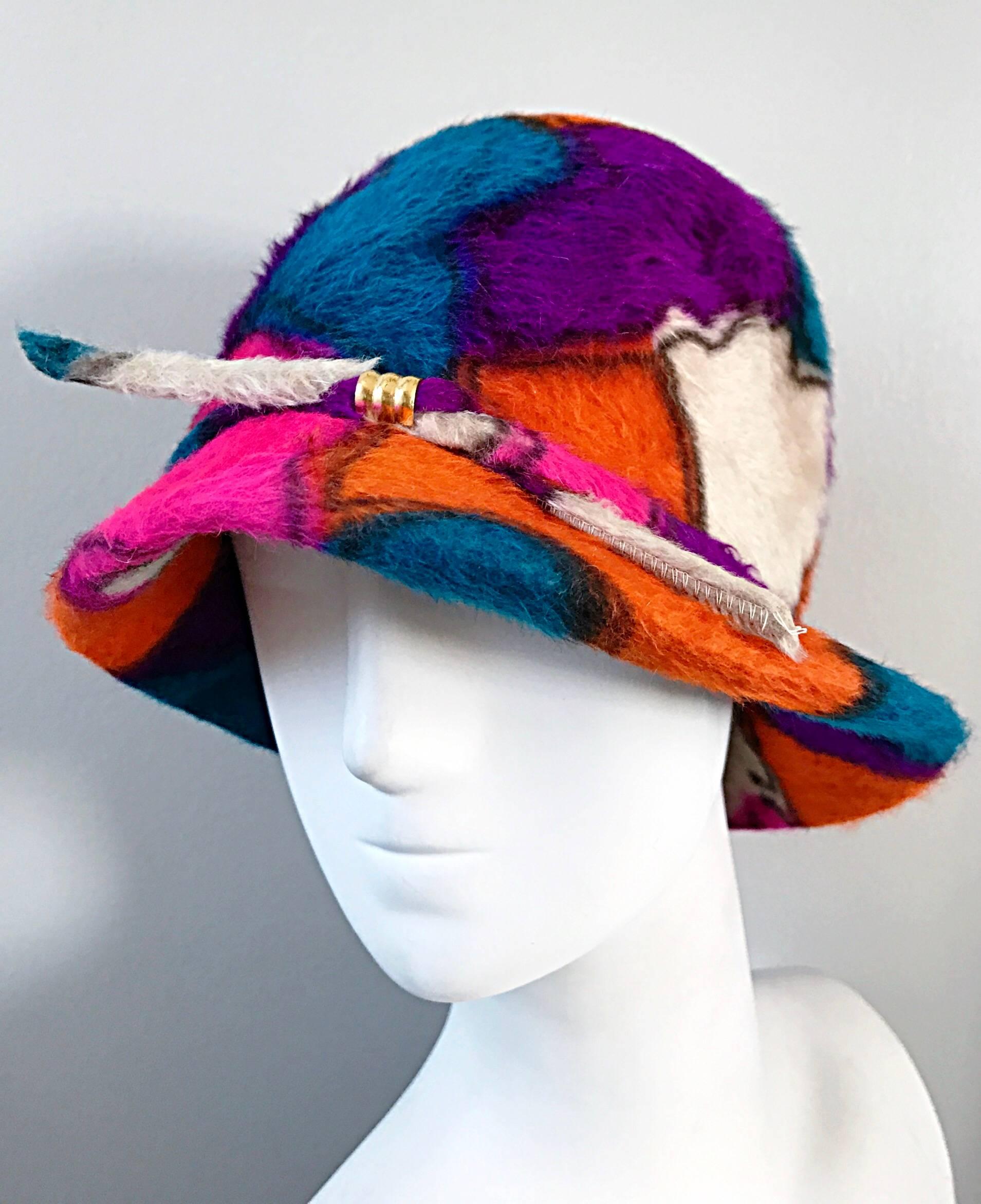 Rare 1960s YVES SAINT LAURENT color block abstract printed cloche hat! Features vibrant hues of purple, orange, fuchsia pink, blue and ivory throughout. Band across the entire hat, with a center gold loop. Looks amazing on! Great with jeans, a