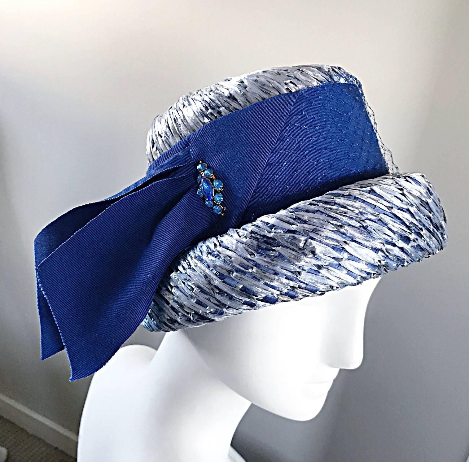 Gorgeous, and brand new with original tags, 1950s BERESFORD blue straw hat! Features light blue straw, with a royal blue silk grosgrain ribbon. Blue rhinestone detail at side. Looks amazing on! Couture quality. In great unworn condition. Will fit a