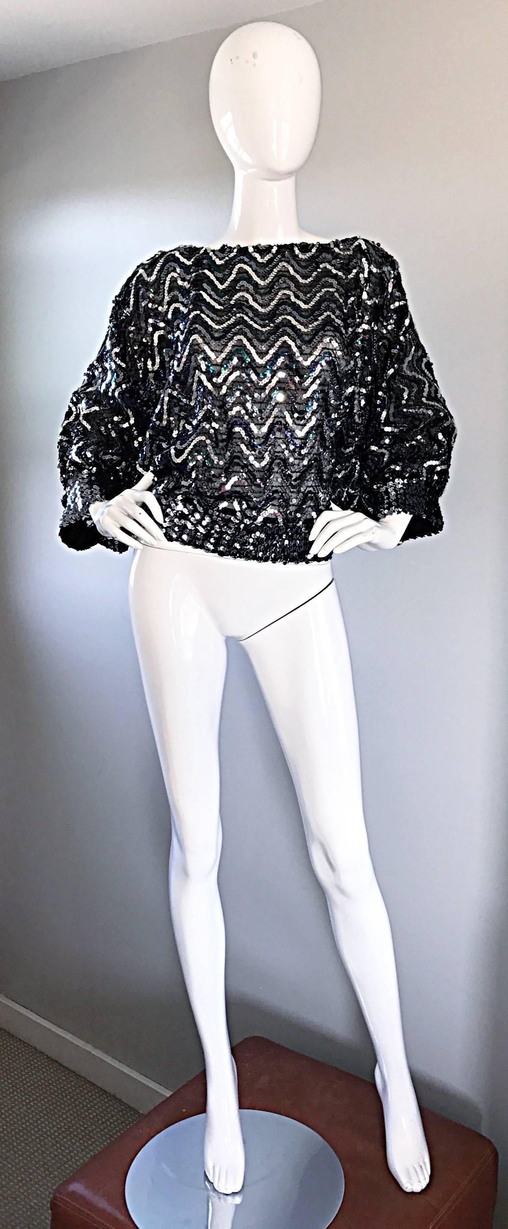 Incredible 1970s sequined dolman sleeve blouse! Features silver and colorful iridescent sequins in a chevron pattern throughout. Studio 54 vibes, with elastic sleeve cuffs and waistband that stretches to fit. Single closure button at top back neck.