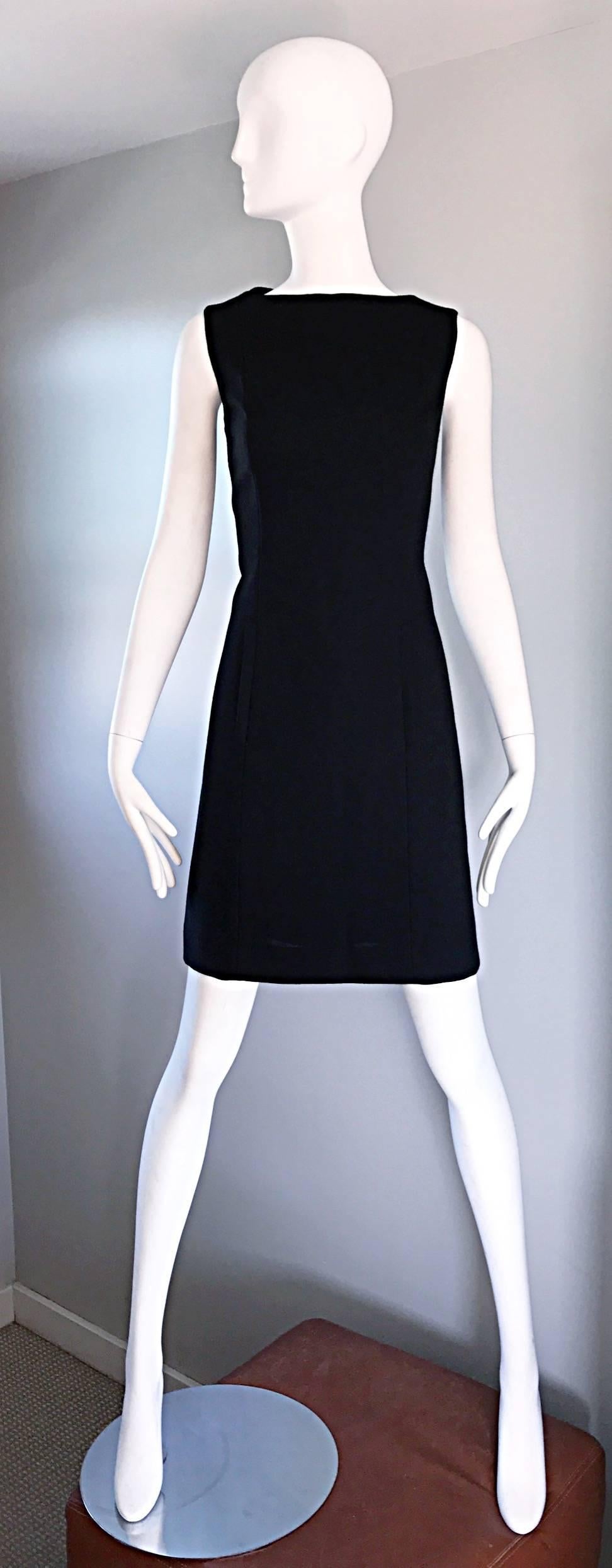Chic and timeless 90s does 60s vintage sleeveless little black dress by design genius Giorgio Armani! This beauty is from the high-end Collecioni brand. 100% soft Virgin wool. Mod shift shape that does wonders for the body! POCKETS at each side of