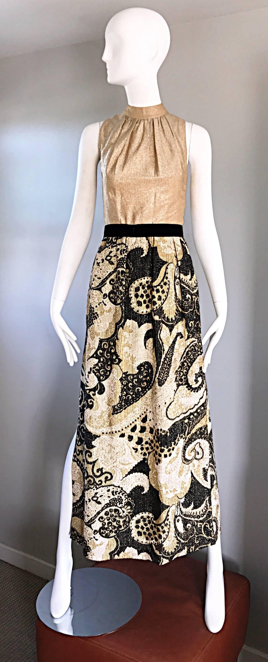 Incredible 1970s vintage gold and black metallic Lurex maxi dress / romper / jumpsuit with attached hot pants (shorts) underneath. Fitted gold bodice, with a high pleated neck. Attached black silk velvet belt. Wild gold and black batik printed full