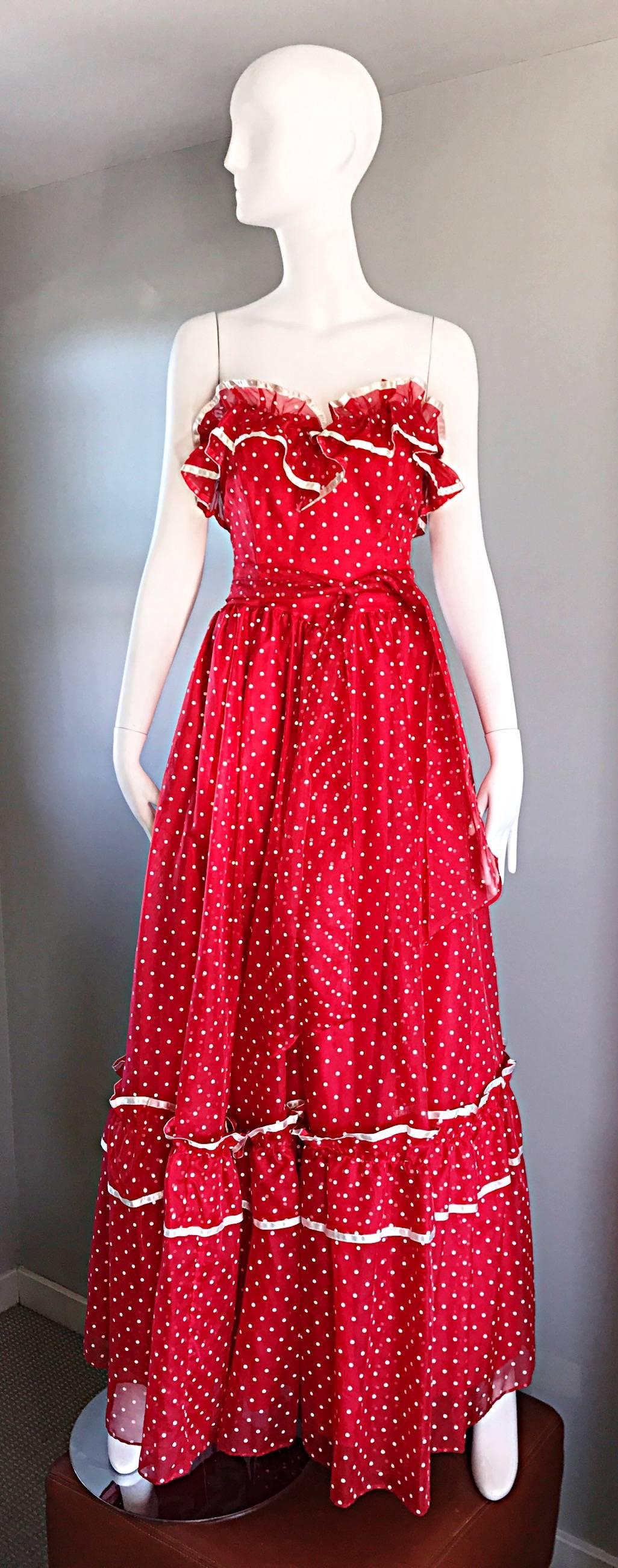 Insanely chic vintage 1970s red and white hand painted polka dot maxi dress! Features an allover print of mini white polka dots. Ruffles above bust, and at mid hem. Attached sash belt can be tied in the front or back. Hidden zipper up the back. Can