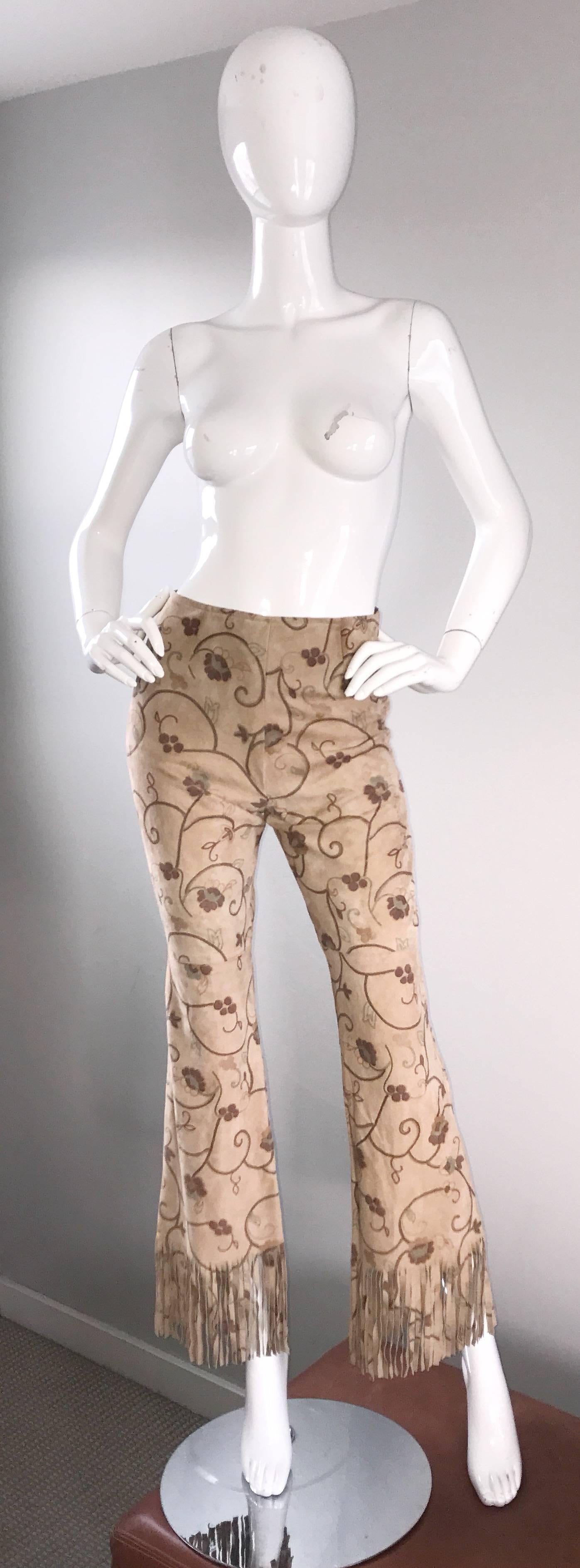 Amazing vintage 1990s ESCADA light brown / tan hand painted boho leather suede pants! Mid-rise fit, with tailored legs, and a wide flare leg that features awesome fringe hems. Super flattering fit! Hidden zipper up the side, with hidden button