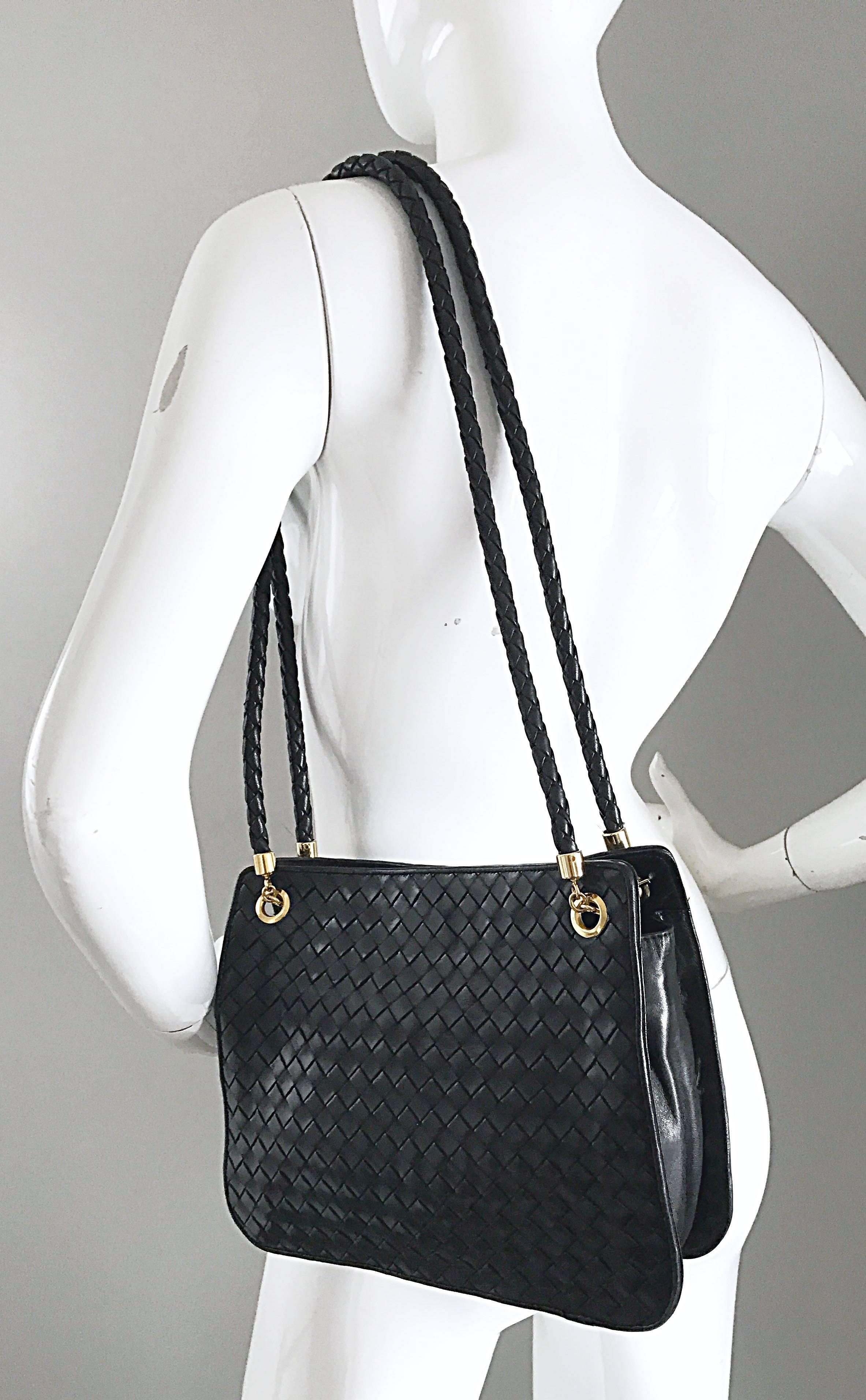 Timeless, and so chic vintage BOTTEGA VENETA black woven Napa leather shoulder bag! Features the classic BV soft Napa leather in their signature woven design. Braided double straps, with gold hardware, fit wonderfully on the shoulder. Snaps shut,