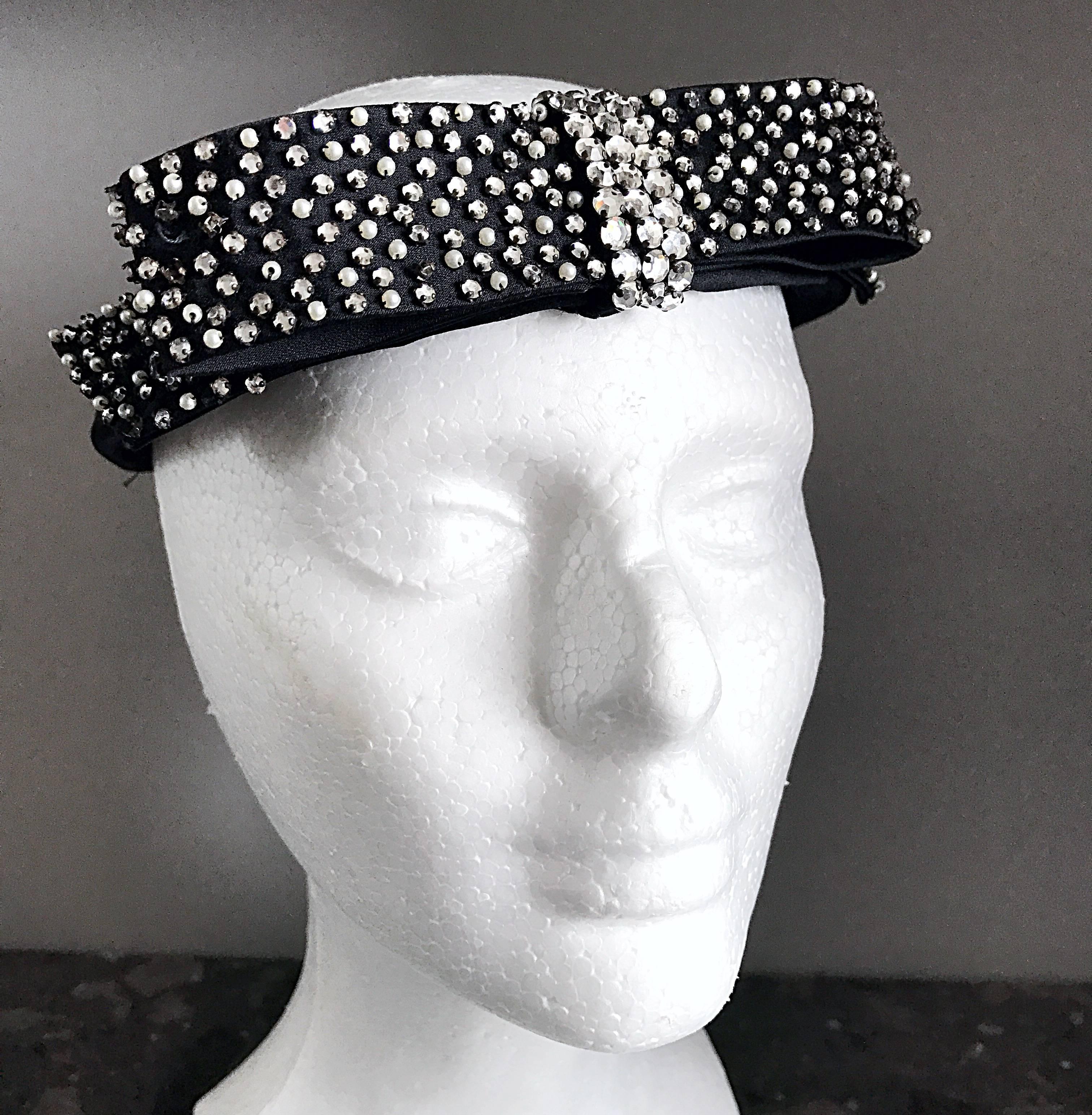 Chic vintage I MAGNIN black silk halo hat! Features a front bow encrusted with rhinestones and mini pearls. Soft black silk satin. Looks great with jeans, or with a dress. Actually, a quite versatile piece! In great condition, with a couple of