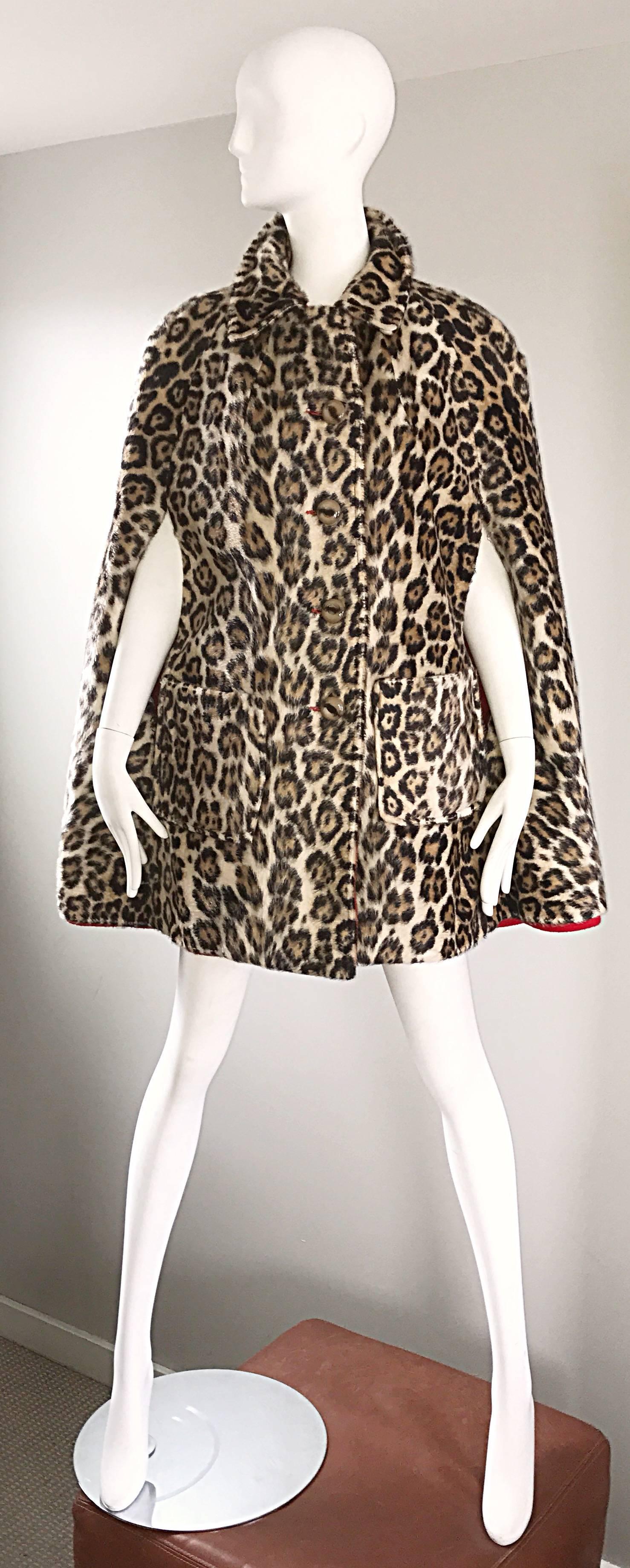 Chic vintage 1960s reversible faux fur and wool 60s cape! Features a soft leopard faux fur on one side, and a bright red wool on the other side. Pockets at each side of the waist (on both sides). Buttons up the front. Very well made, and could