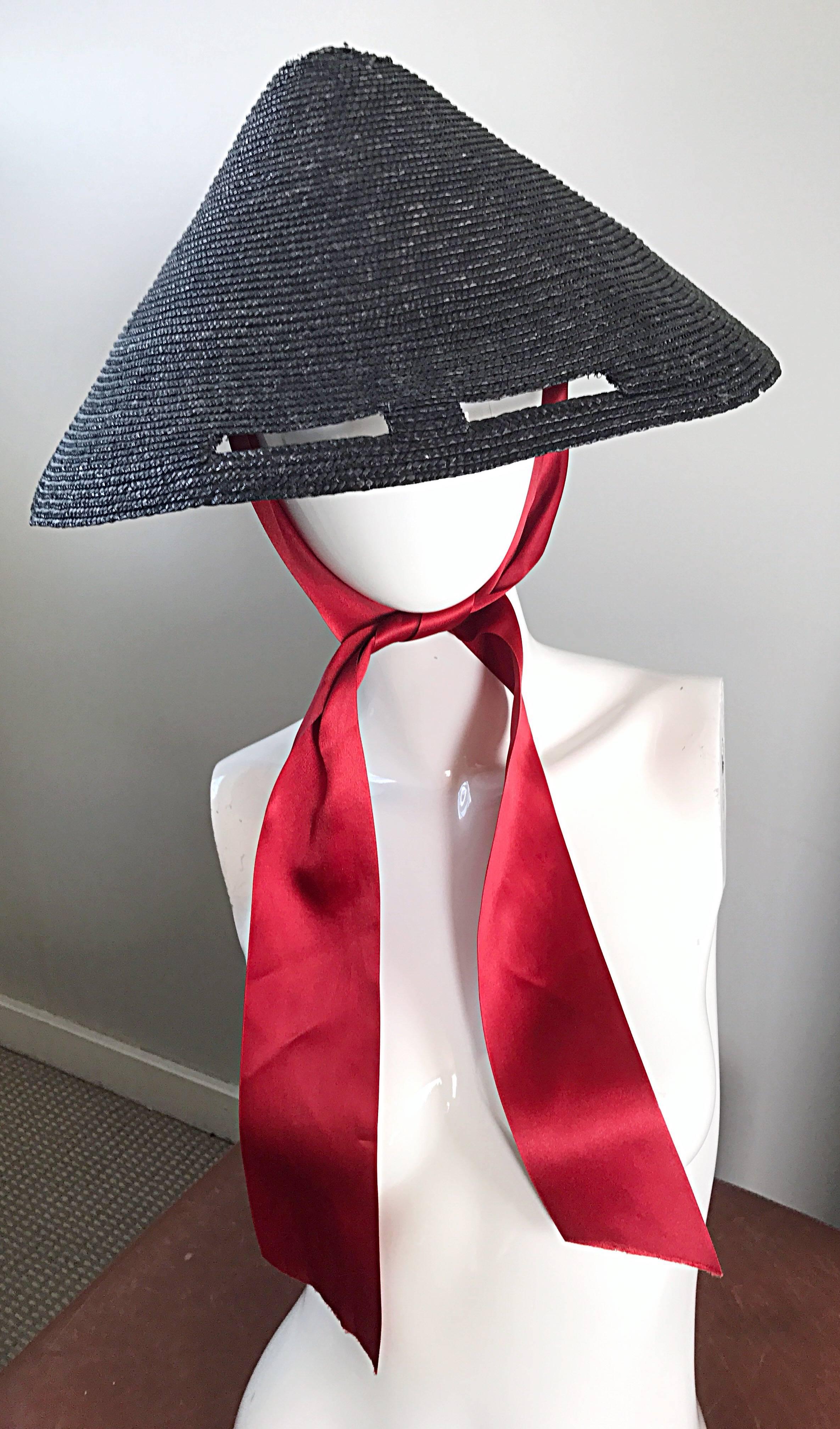 Rare 1950s black straw hat with cut out slits for the eyes, and red silk ribbon tie! Cone shaped, with inner brim. Attached red silk ribbon ties under the neck. So unique and chic! In great unworn condition. Will fit most any head size due to shape.