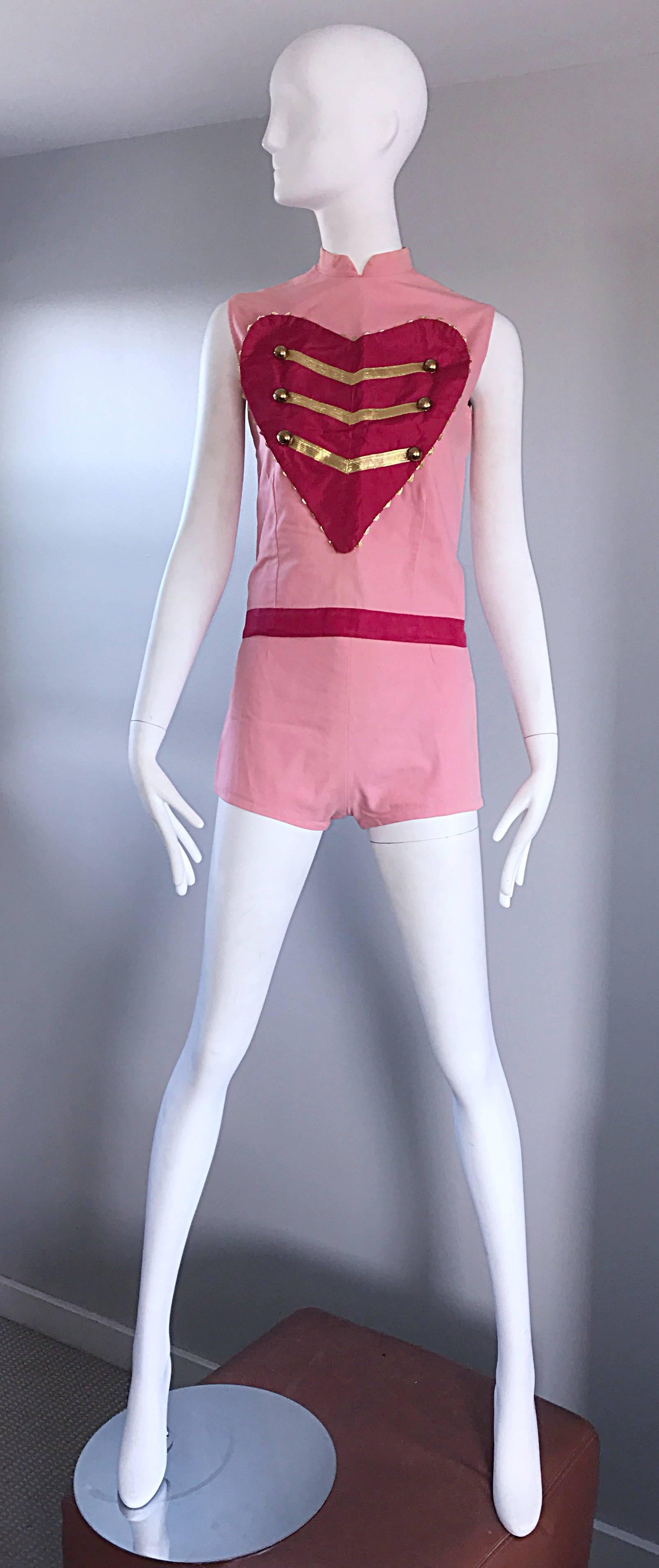 Rare and amazing vintage 1960s pink Las Vegas showgirl marching band ensemble! High waisted tailored shorts, and a slightly cropped sleeveless top. Short feature a metal zipper up the back. Blouse features a large red heart, with gold