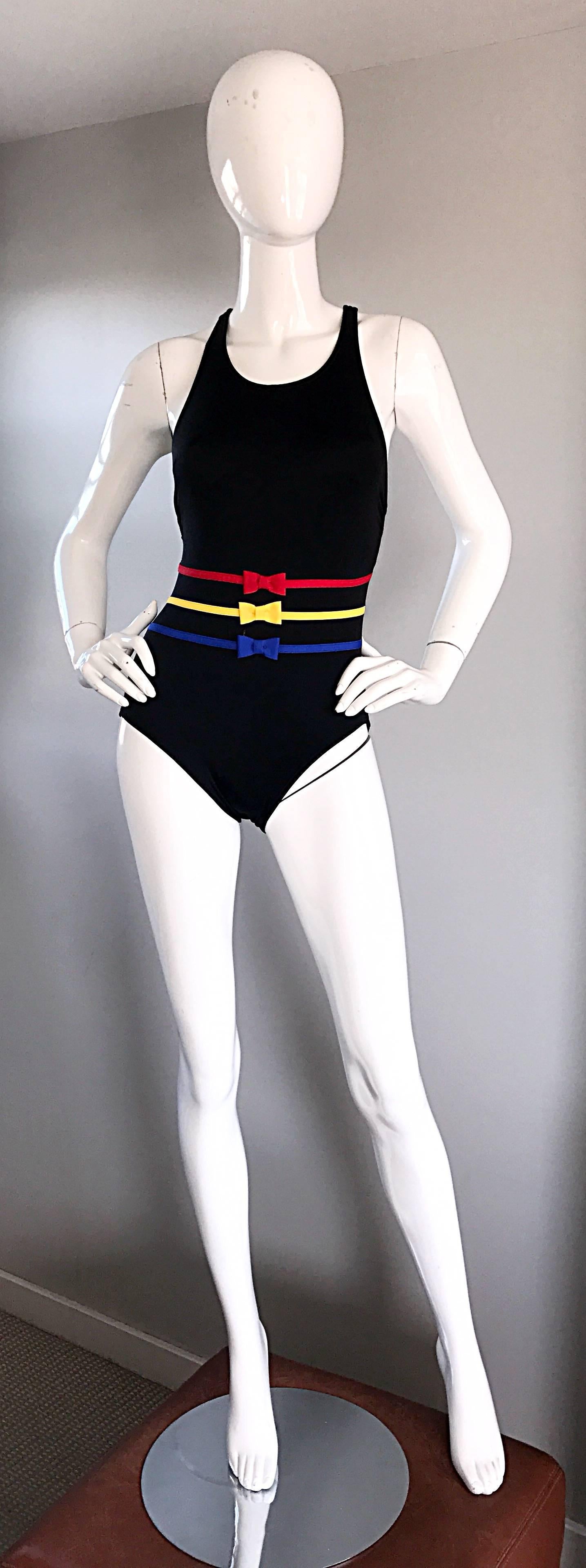 Chic new (never worn) vintage BILL BLASS 1990s one piece swimsuit or bodysuit! Jet black color, with yellow, blue and red ribbon and bows across the waist. Super flattering fit stretches to fit the body. Sexy open back, with hook closure at back