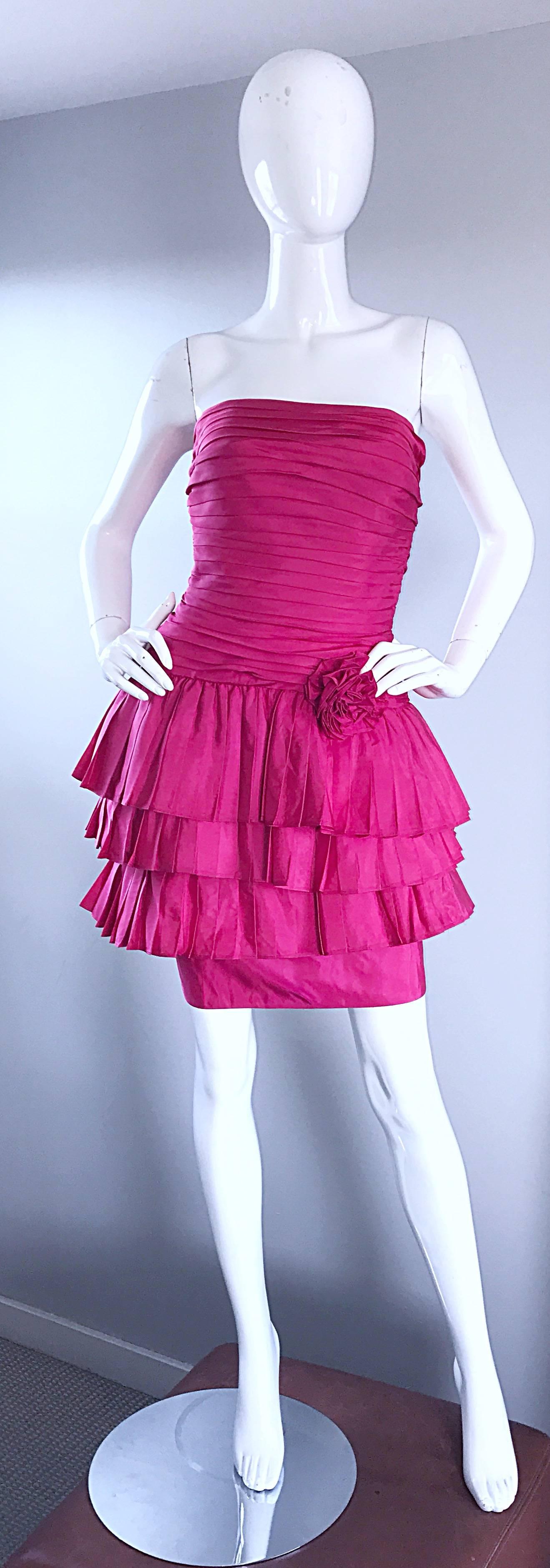 Wonderful vintage early 90s TADASHI SHOJI shocking hot pink fuchsia strapless cocktail dress! Features panels of silk on the bodice, with a tiered ruffle skirt. Corsage detail at left center waist. Hidden zipper up the side with hook-and-eye