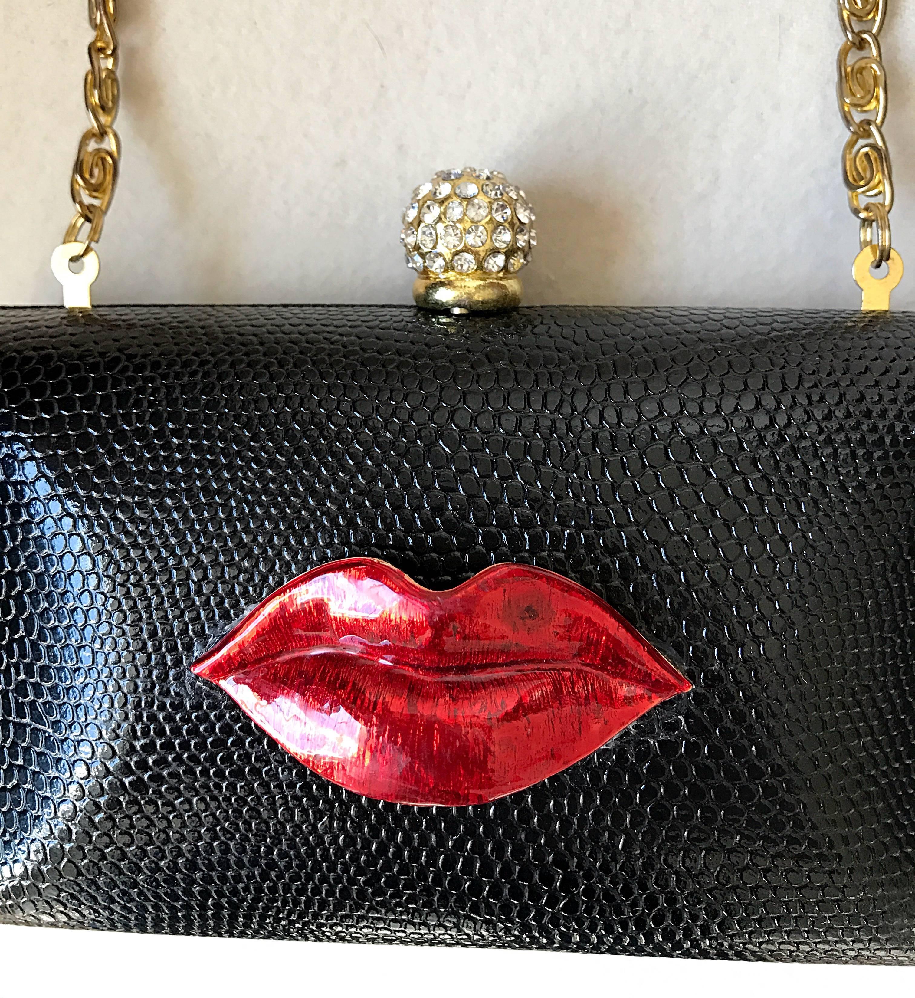 Super rare 1990s IRIS LANE Valentine Day vintage black and red lizard embossed leather minaudière convertible clutch! Features an allover black embossed tejus lizard leather body, with an attached lip 'KISS' lipstick red enamel appliqué. Perfect for