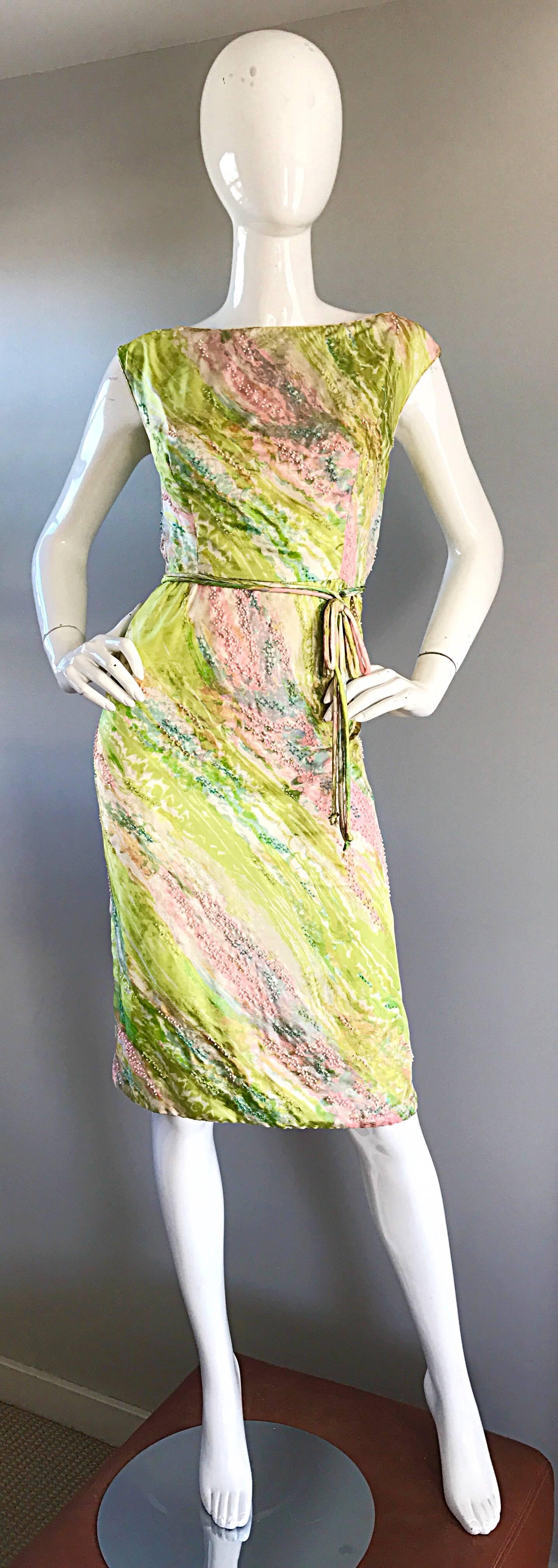Sensational late 1950s, early 1960s 60s luxurious silk watercolor beaded dress! Features vibrant green, pink, blue and white colors throughout. Thousands of hand-sewn seeds beads throughout. Attached bow self belt at waist. Full metal zipper up the