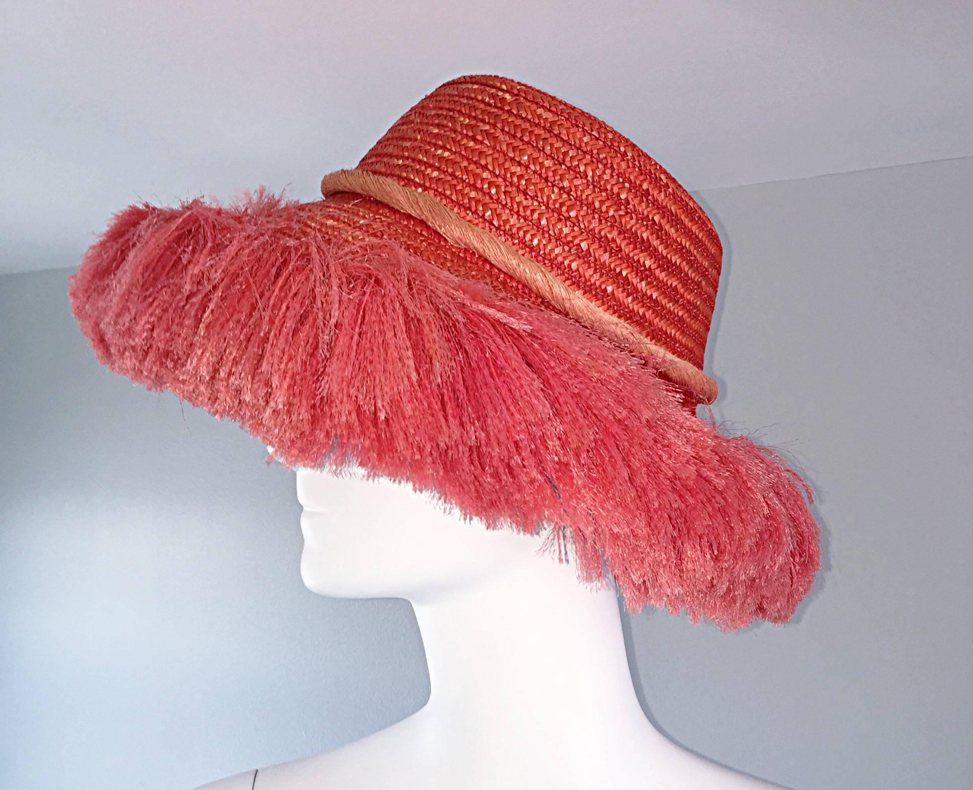 Chic vintage 1960s straw / raffia 'fringe' hat! Soft straw, with light and fluffy fringe around the brim. Attached rope in a lighter pink, with fringe in the back. Attached black elastic strap to keep the hat on. Looks amazing on! Will fit most
