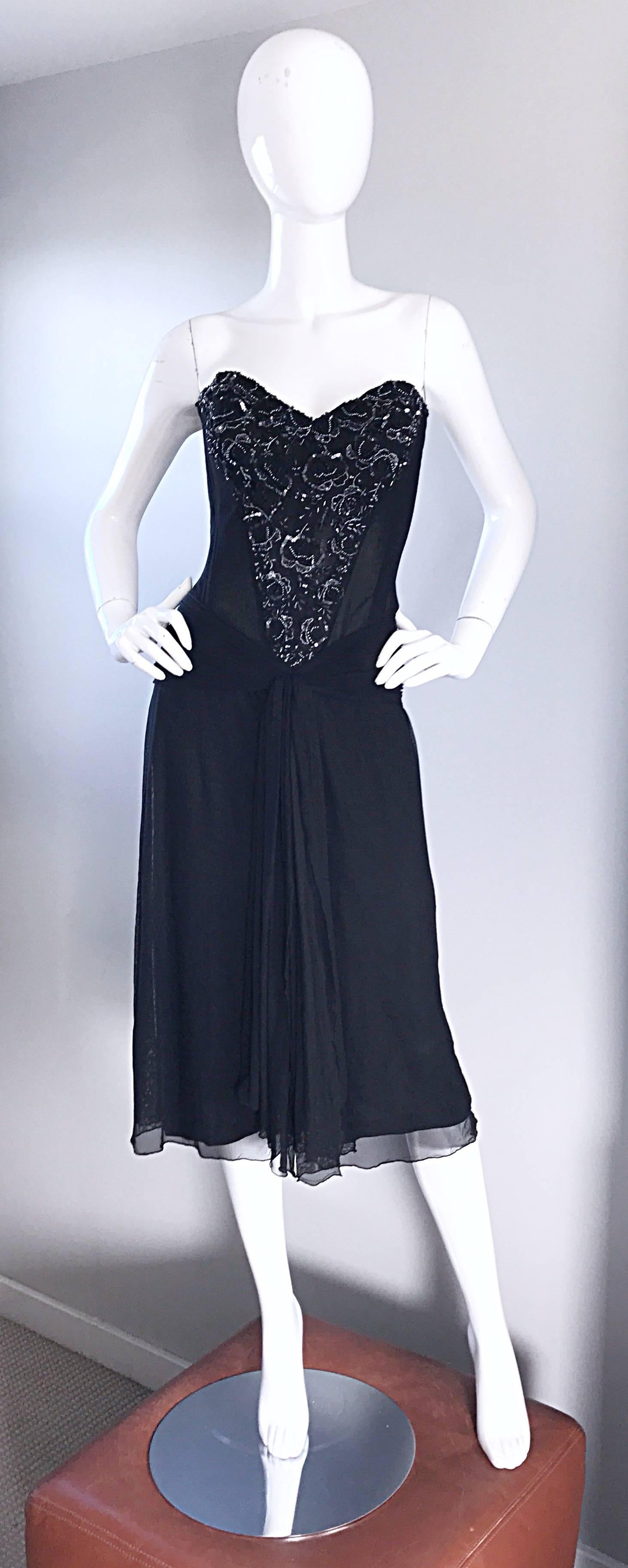 Sexy vintage VICKY TIEL COUTURE black sequin and beaded flapper style dress! Features a boned corset with silk mesh. Hundreds of hand sewn glass beads and sequins throughout the bodice. Hidden zipper up the back with hook-and-eye closure. Gathers at