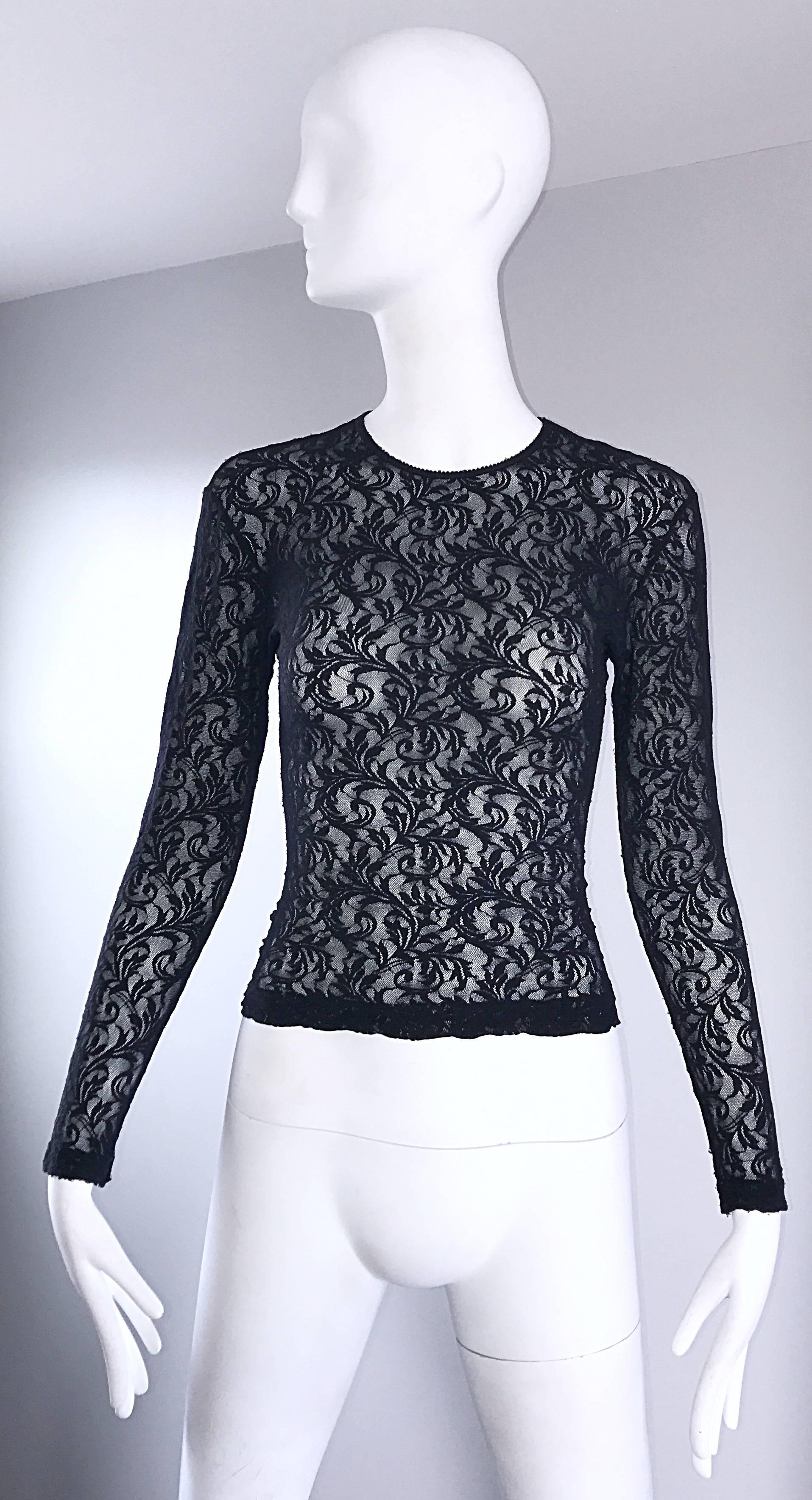 Sexy vintage 90s CALVIN KLEIN black lace cropped top shirt ! Features a fine soft lace that stretches to fit. Tailored body, with sleek long sleeves. Looks amazing on! Perfect with shorts, jeans, trousers, or a skirt. In great condition.
Made in