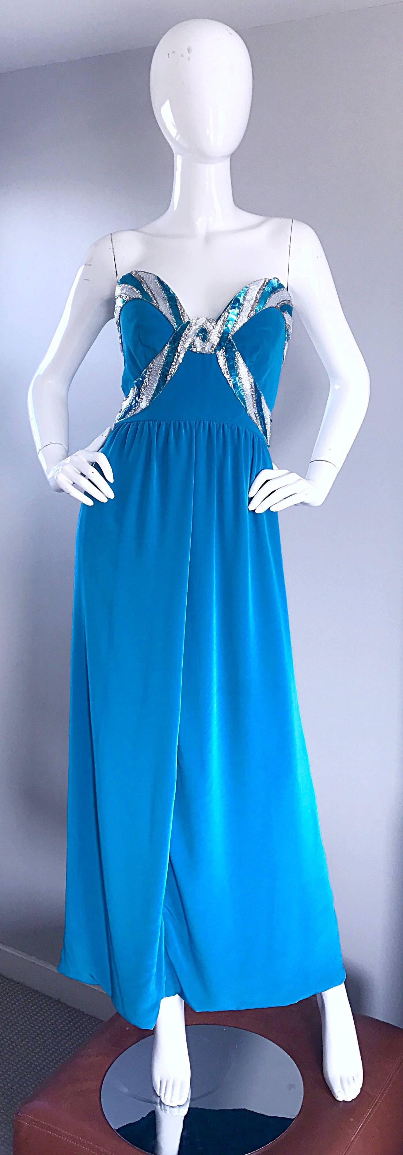 Gorgeous vintage BOB MACKIE turquoise/ teal blue strapless gown! Striking vibrant color! Strapless fit, with a boned bodice that features hundreds of hand-sewn sequins in silver and blue. Hidden zipper up the back with hook-and-eye closure. Grecian