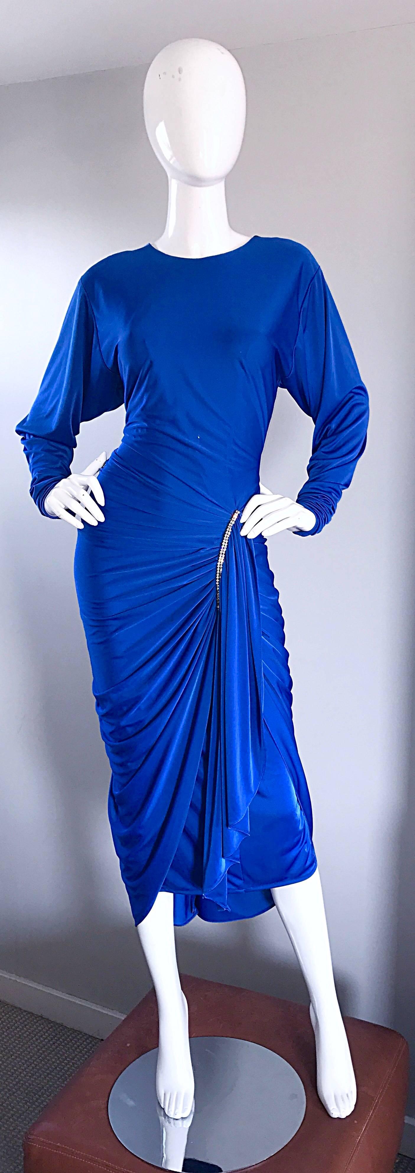 Sexy, yet sophisticated vintage late 1970s vibrant royal blue jersey disco dress! Ruched waist and skirt is very flattering, and hugs the body in all the right places. Fitted bodice, with dolman sleeves can accomodate an array of bust sizes.