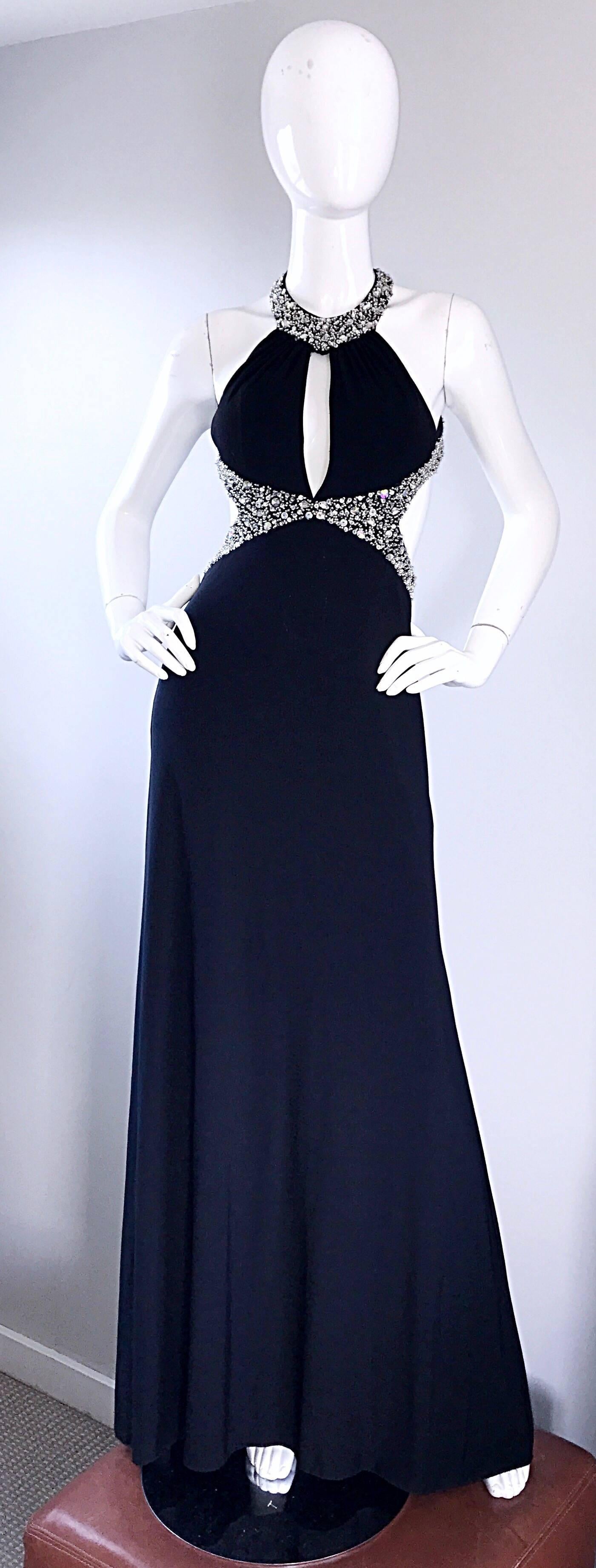 Sexy 90s custom made black jersey cut-out gown! Crystal rhinestone beaded halter neckline, with a matching beaded and sequined waistband. Cut-outs at the side, with a plunging neckline. Multiple layers of jersey fabric hug the body in all the right
