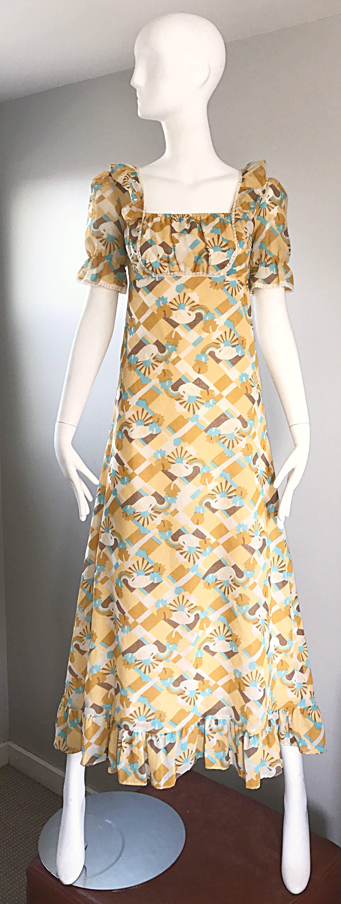 Outstanding vintage 1970s swan print novelty maxi dress! Features blue, yellow, brown and white colors, with swans printed throughout. Features a ruffled hem, puff, sleeves, and ruching at the bodice. Hidden metal zipper up the back. Very good