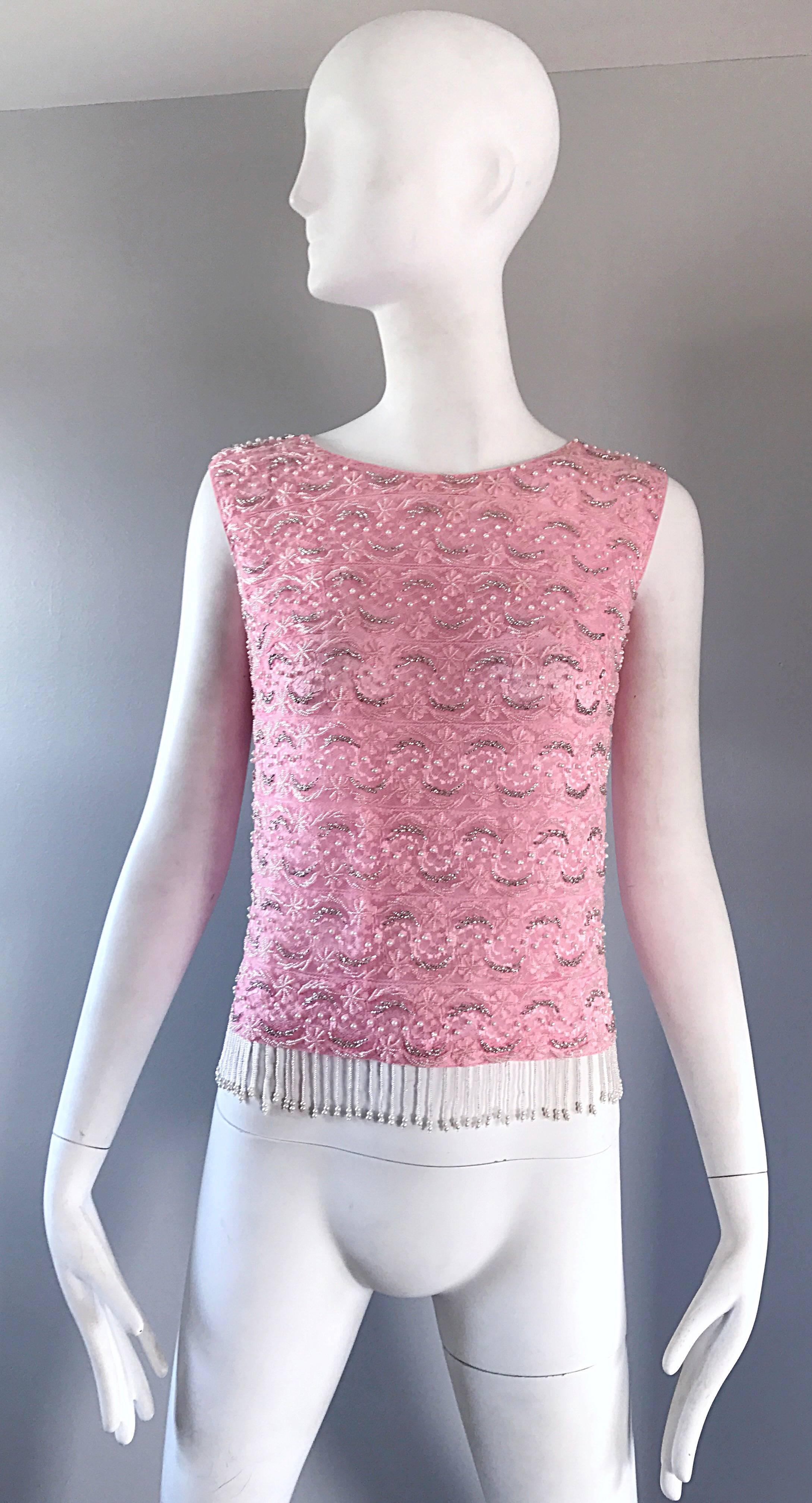 Chic 60s pink silk beaded top! So much detail to this gorgeous little gem! Lace, pearls, sequins and beads throughout. Super soft silk feels amazing against the body! Beaded fringe on the hem. Full metal zipper up the back with hook-and-eye closure.