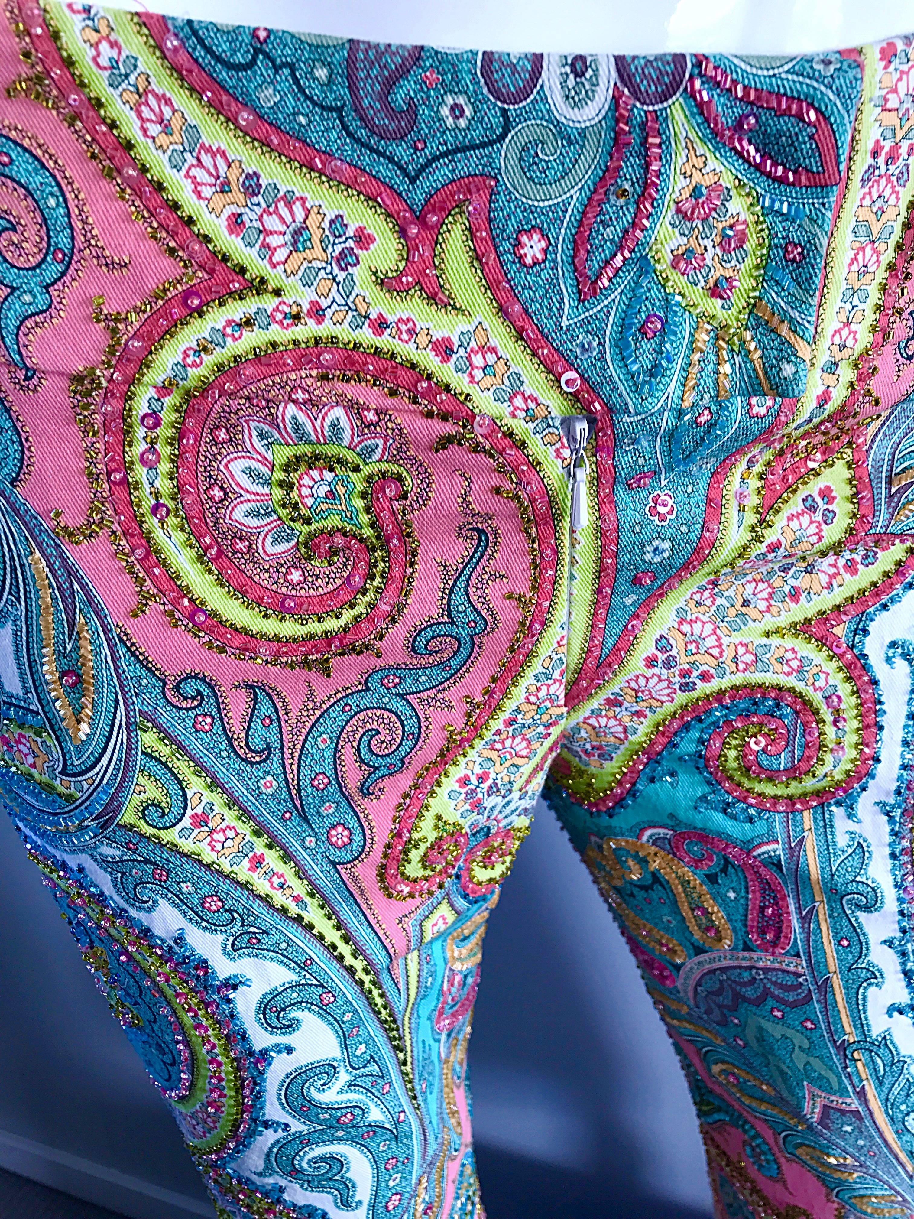 Incredible CARMEN MARC VALVO 90s fully beaded colorful paisley flared leg low rise trousers! Features thousands of hand-sewn beads throughout the front and back. Flattering low-rise fit. Vibrant hues of pink, blue, coral, green, teal and white.