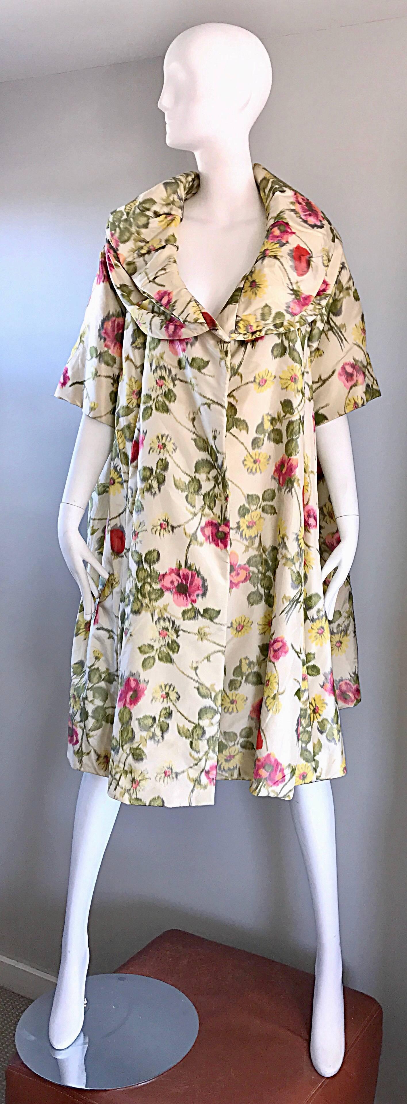 Beautiful late 50s LILLIE RUBIN silk opera jacket! Features roses and flowers in pink, yellow and green throughout, with ivory background. 3/4 sleeves, with a multiple layered collar. Fully lined. A classic gem that looks amazing on, and can fit an