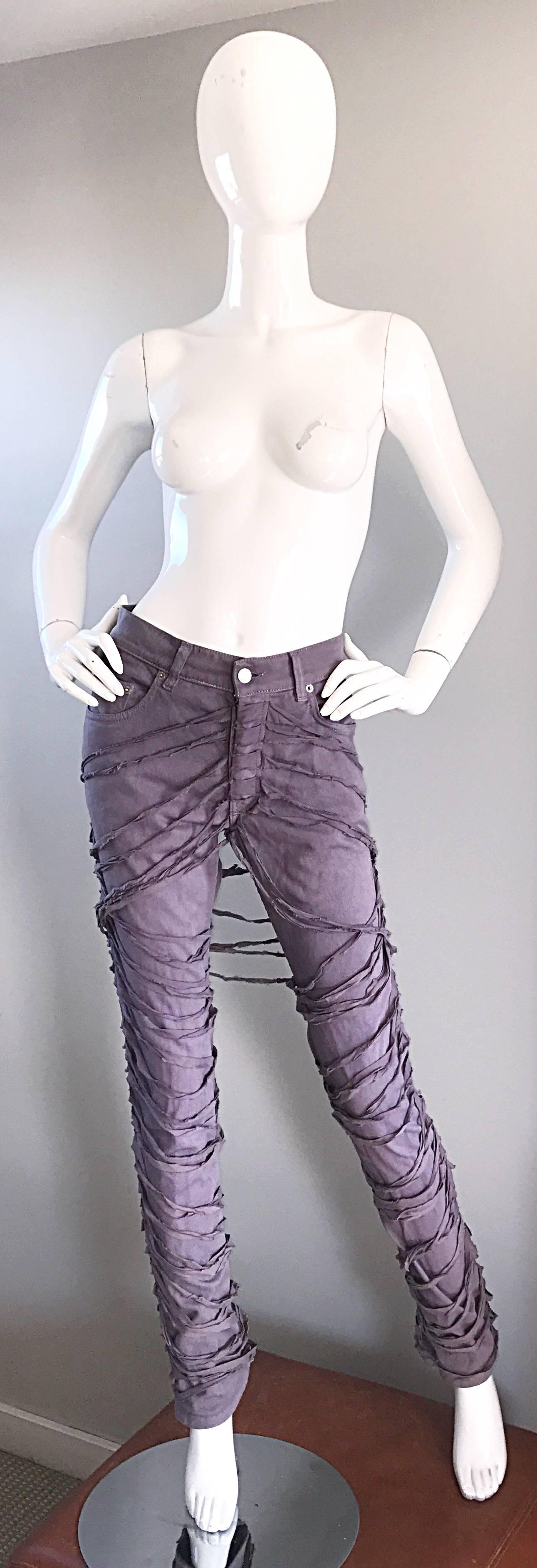 Extremely rare HELMUT LANG Autumn / Winter 2004 famous bondage mummy blue jeans! Fantastic light purple / gray color looks great with anything! Flattering high waist slim tailored fit. Features strips of fabric around the legs. Pockets at each side