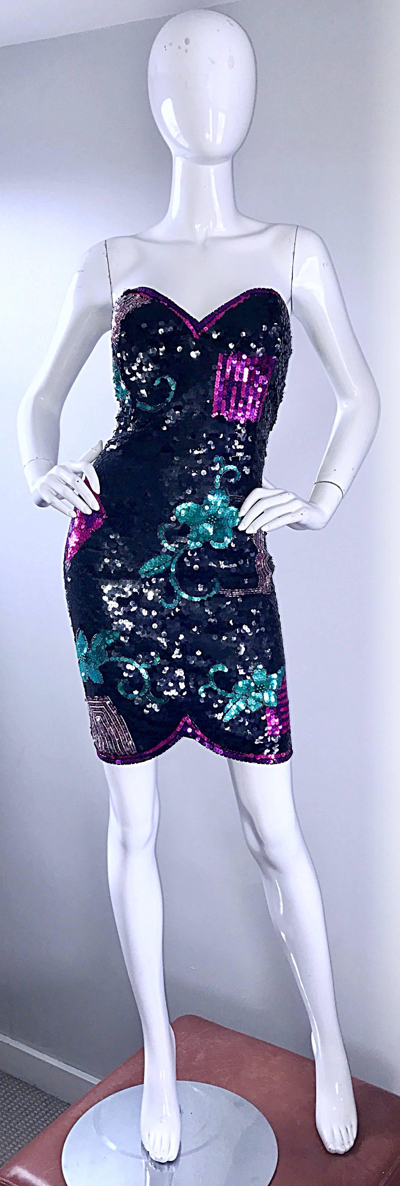Sexy larger size strapless sequin dress! Features thousands of hand-sewn sequins and beads throughout. Asymmetrical hem dips slightly shorter on the center front. Black sequins, with pink, green and purple sequined designs thorughout. Very