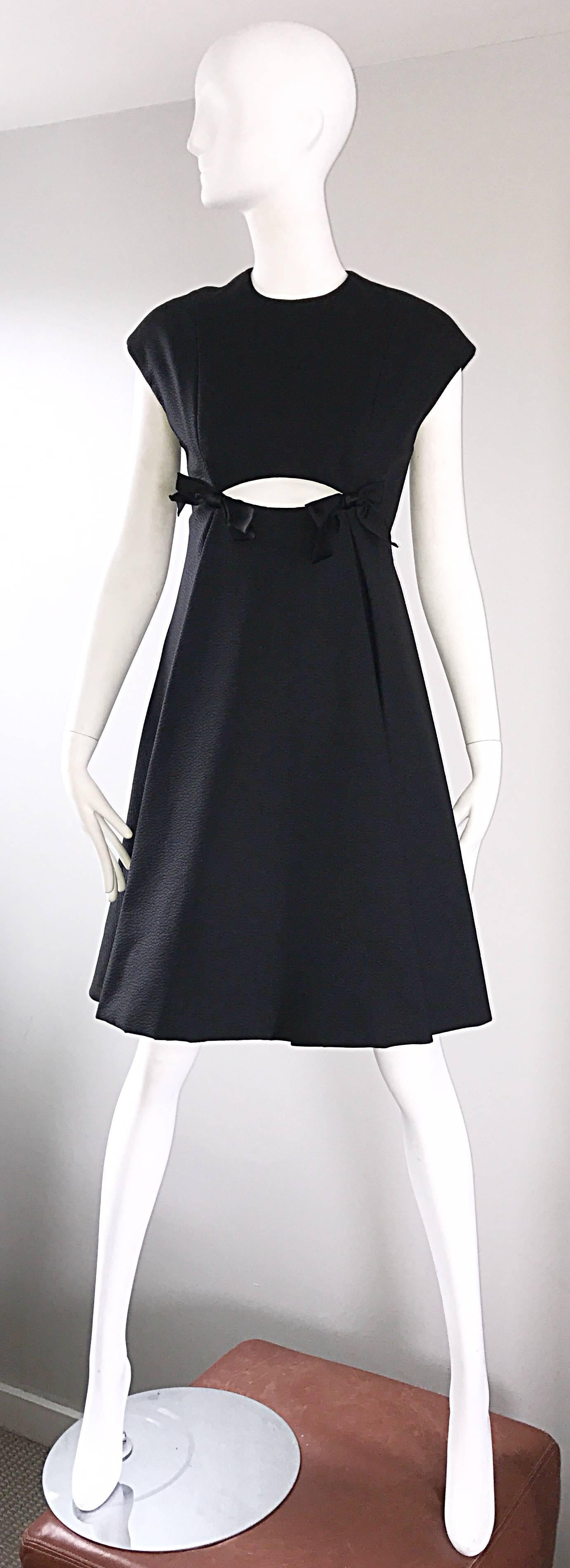 Rare MUSUEM QUALITY vintage 60s GEOFFREY BEENE black silk cut-out short sleeve A-Line dress! This one's for the musuems! Classic black dress, with a mod twist. Cut-out below the bust, with two black satin bows. Heavy duty silk holds shape nicely.