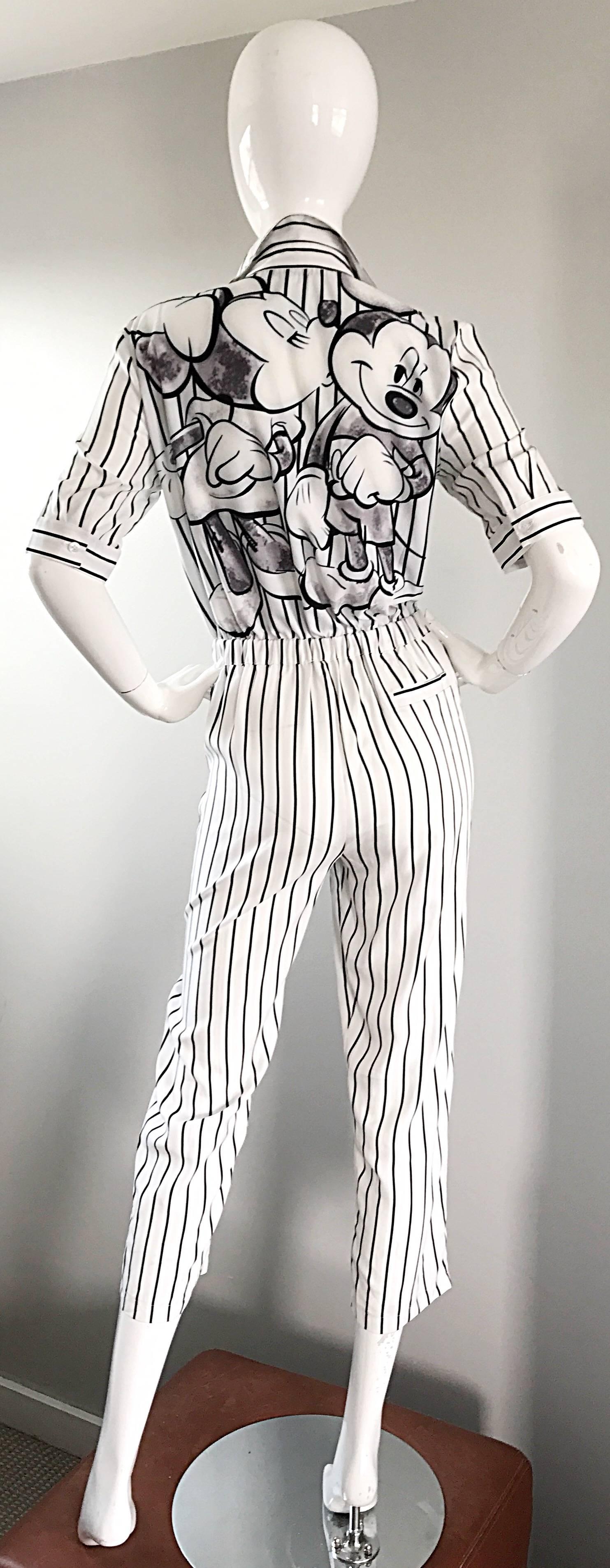 Spectacular and rare vintage 90s PRADA jumpsuit! Features black and white vertical stripes, with a screenprint on the back with Minnie kissing Mickey. Classic shirt style cropped jumpsuit, with buttons up the bodice, and at each sleeve cuff. Pocket