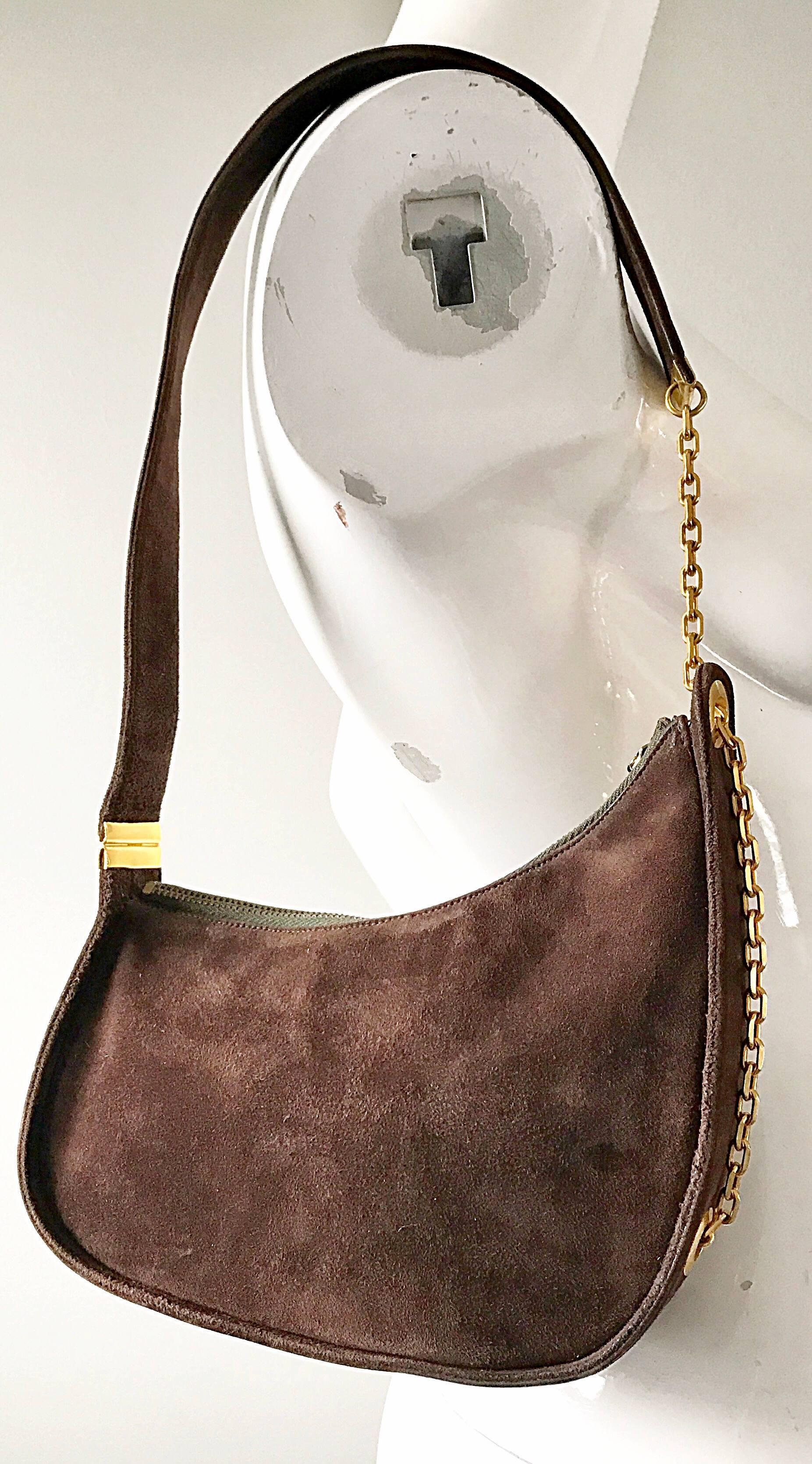 Amazing and rare 50s vintage KORET bag! Avant Garde asymmetrical shape that easily sits on the shoulder. Gold chain detail adds a little something extra. Lined in leather, and features a single zipped compartment inside. Zipper top for security. The