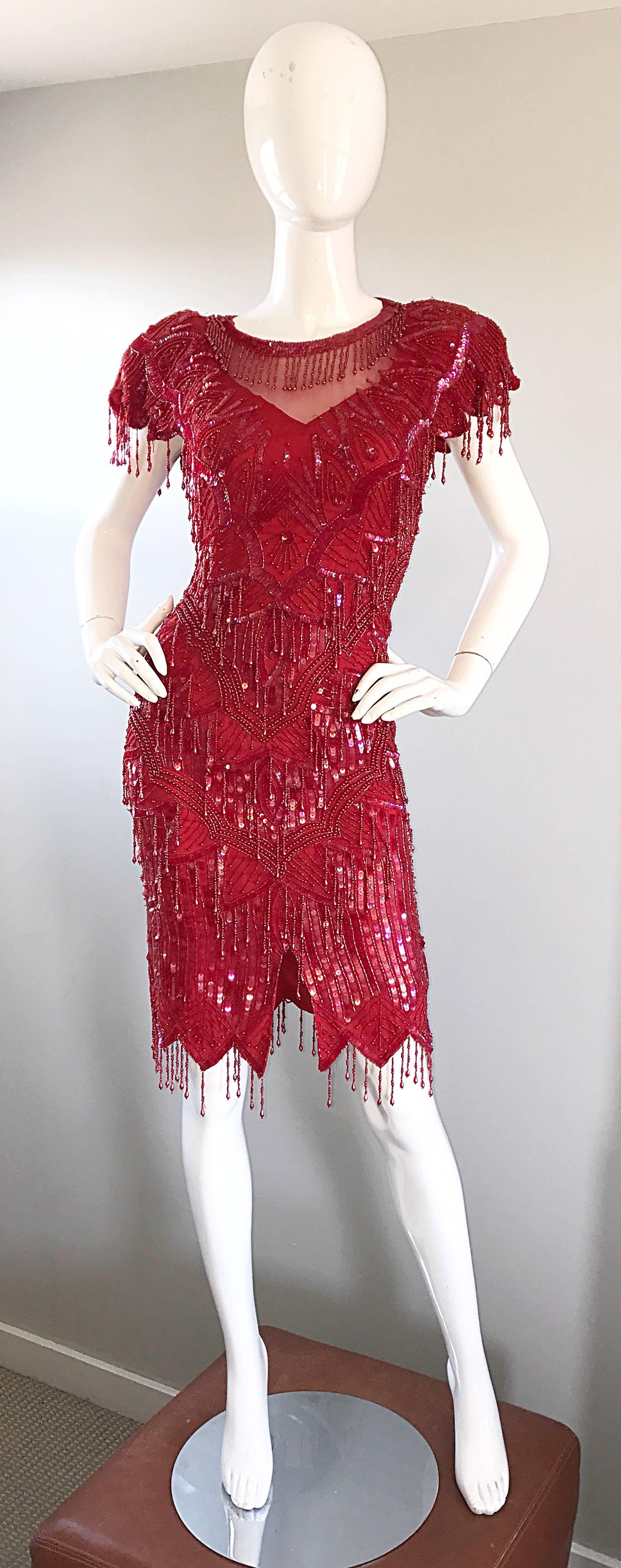 Amazing late 1980s / early 1990s lipstick cherry red silk flapper inspired dress! Beautiful red color, with hundreds of hand sewn sequins and beads throughout. Red fringed beadwork thorughout, with a scallop fringed hem and sleeve cuffs. Semi sheer